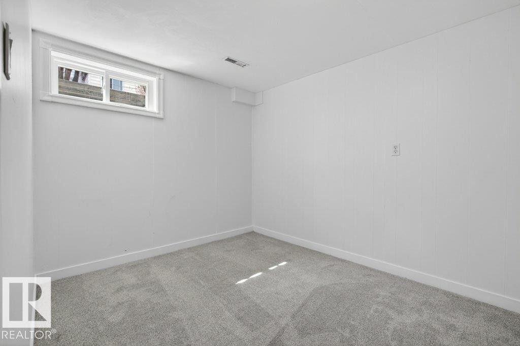 Recessed window with white trim, light gray wall-to-wall carpeting, white painted walls, white baseboards, and a ceiling-mounted ventilation register - 3E Twin Terrace, Edmonton, AB - Indoor Photo Showing Other Room