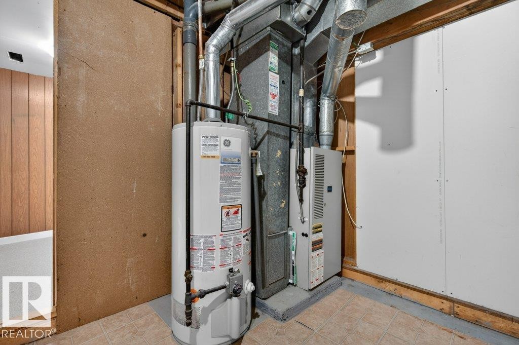Utility area featuring a water heater, furnace, and exposed ductwork - 3E Twin Terrace, Edmonton, AB - Indoor Photo Showing Basement