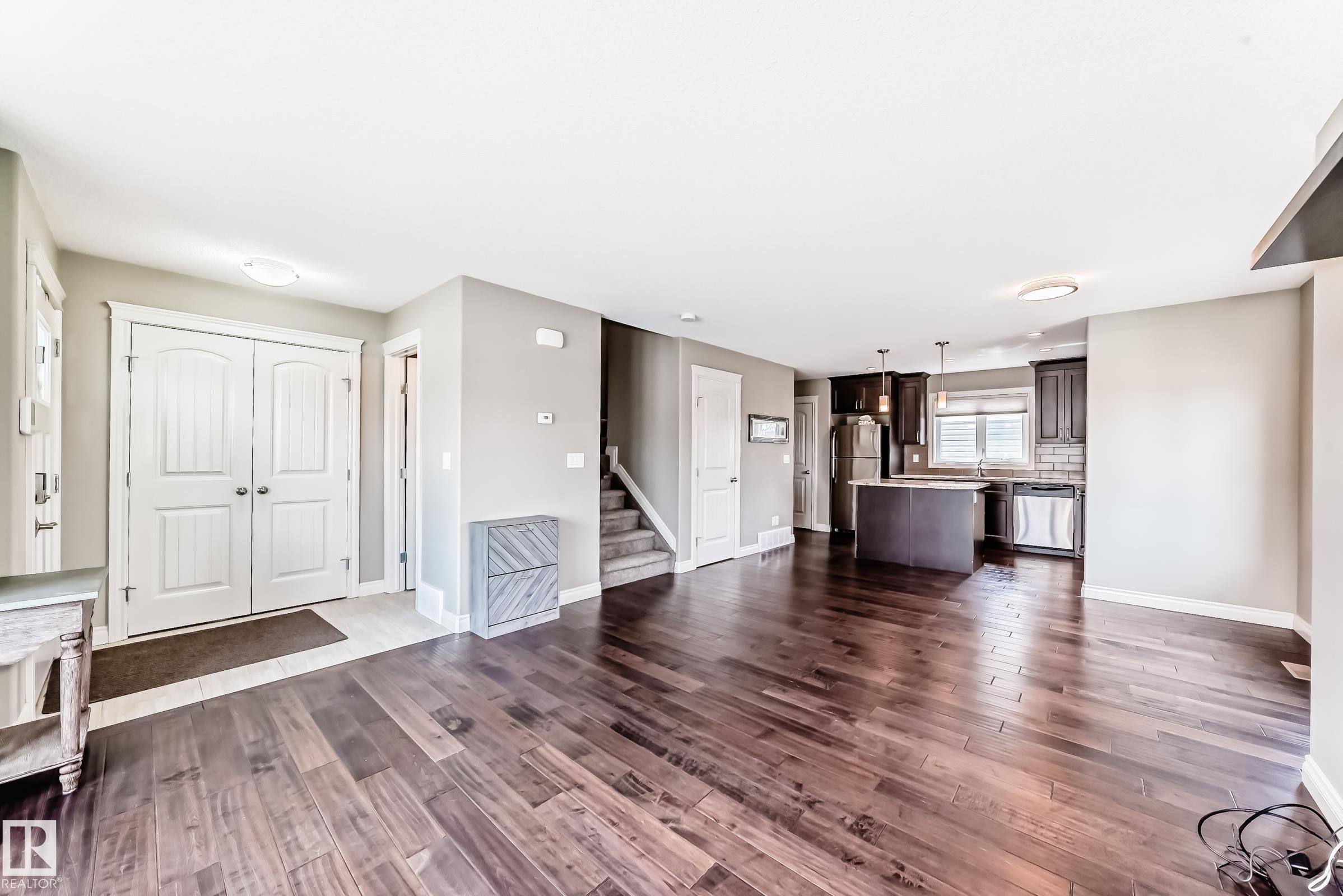 Open concept living area with wood-finish flooring - 10519 114 Avenue, Edmonton, AB - Indoor Photo Showing Other Room