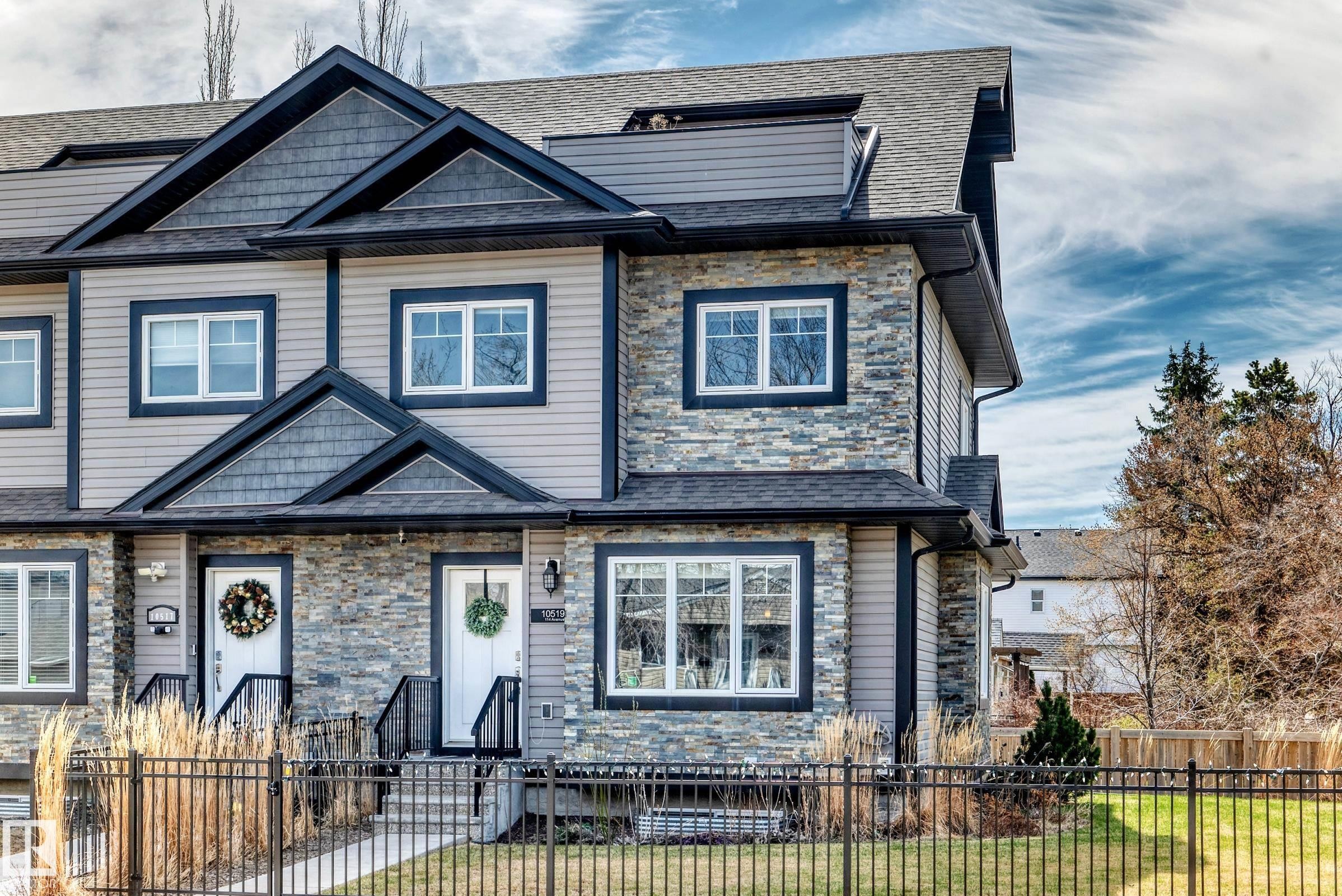 Modern multi-level exterior featuring stone veneer, horizontal siding, and dark trim accents - 10519 114 Avenue, Edmonton, AB - Outdoor With Facade