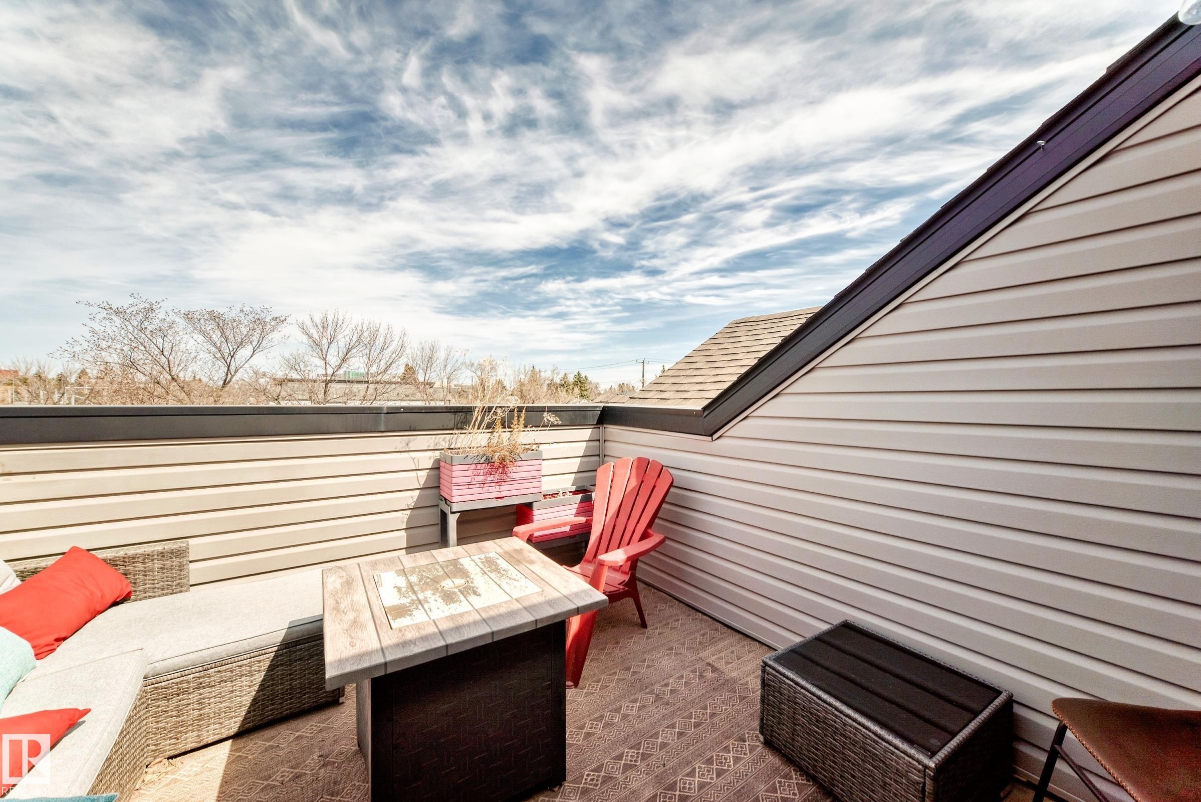 Exterior upper-level deck featuring composite siding and a dark roofline - 10519 114 Avenue, Edmonton, AB - Outdoor With Exterior
