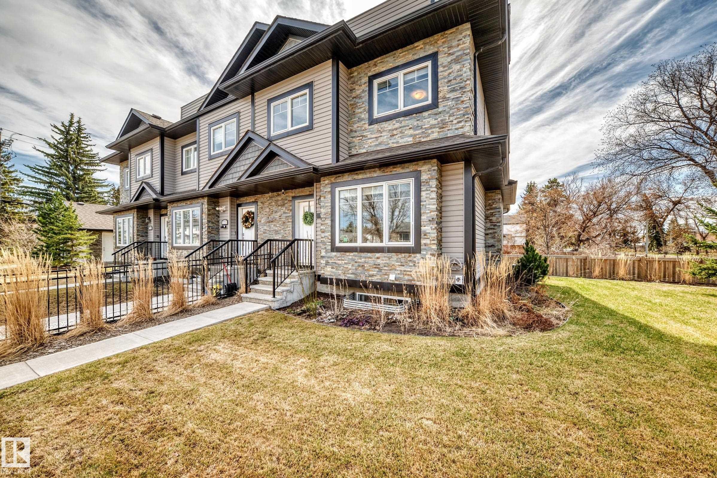 Stacked stone and siding exterior with dark trim accents - 10519 114 Avenue, Edmonton, AB - Outdoor