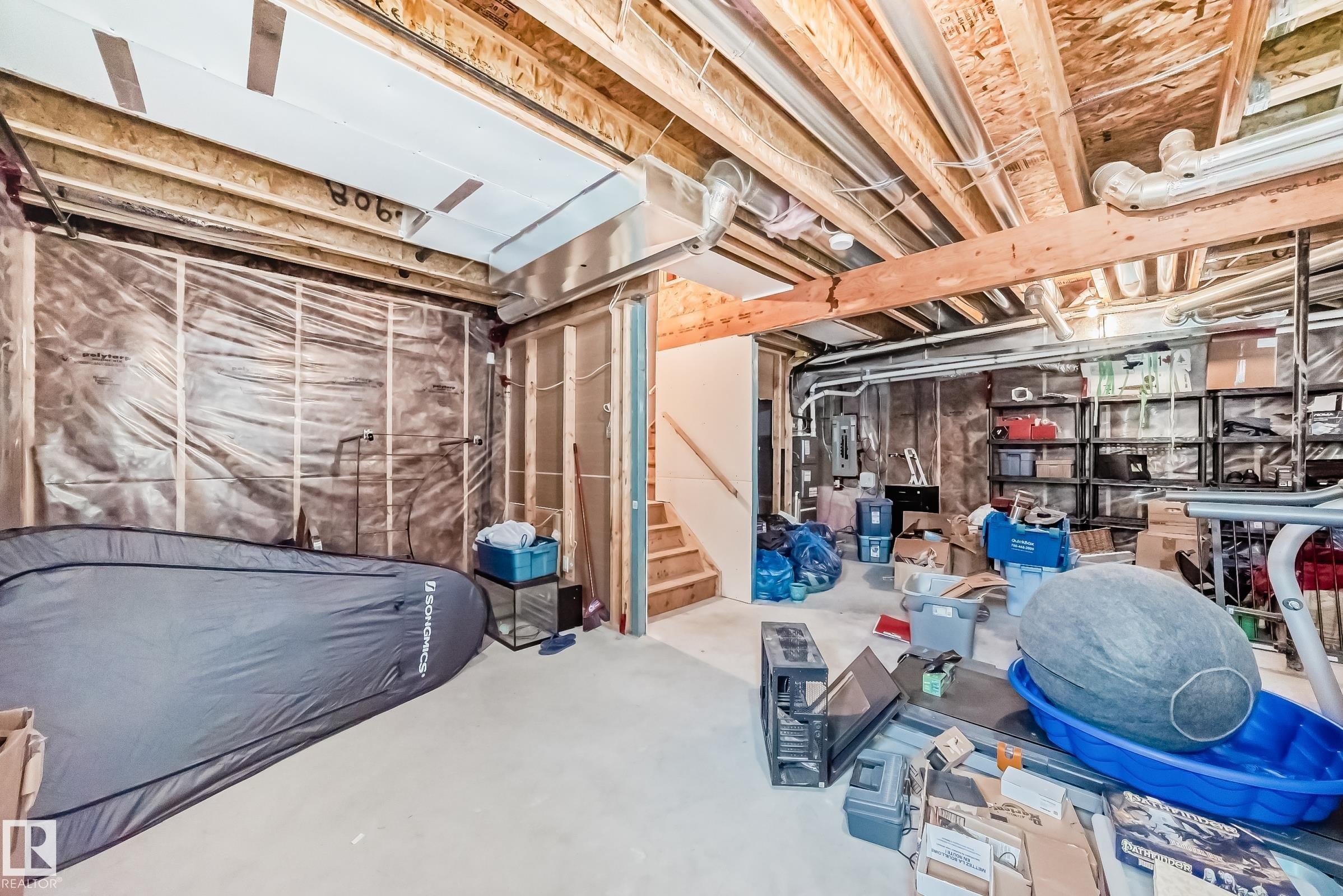Unfinished basement with exposed wood framing, concrete flooring, and visible insulation, offering potential for future development - 10519 114 Avenue, Edmonton, AB - Indoor Photo Showing Basement