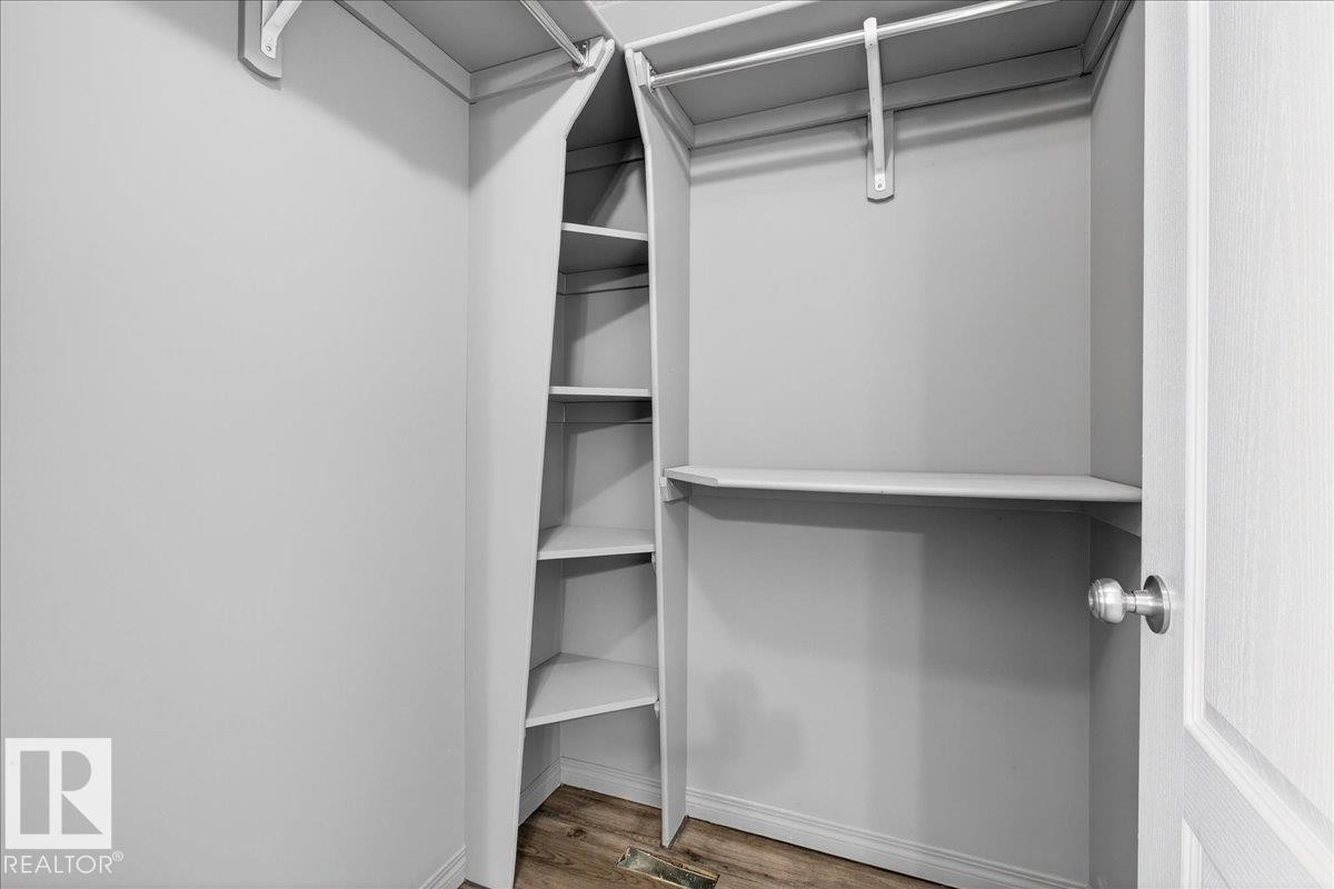 Walk in closet with light wood-style flooring - 150 Acacia Circle, Leduc, AB - Indoor With Storage