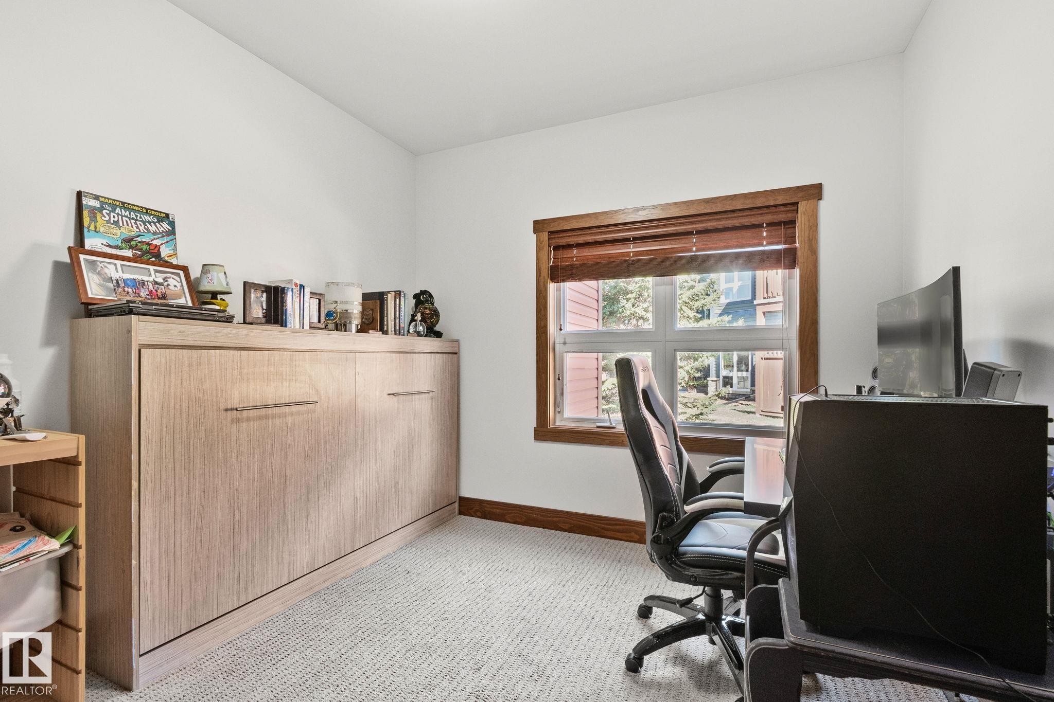 Neutral wall paint, light-toned wall bed cabinetry, and wood-finish window trim - 2201 Graybriar Green, Stony Plain, AB - Indoor Photo Showing Office