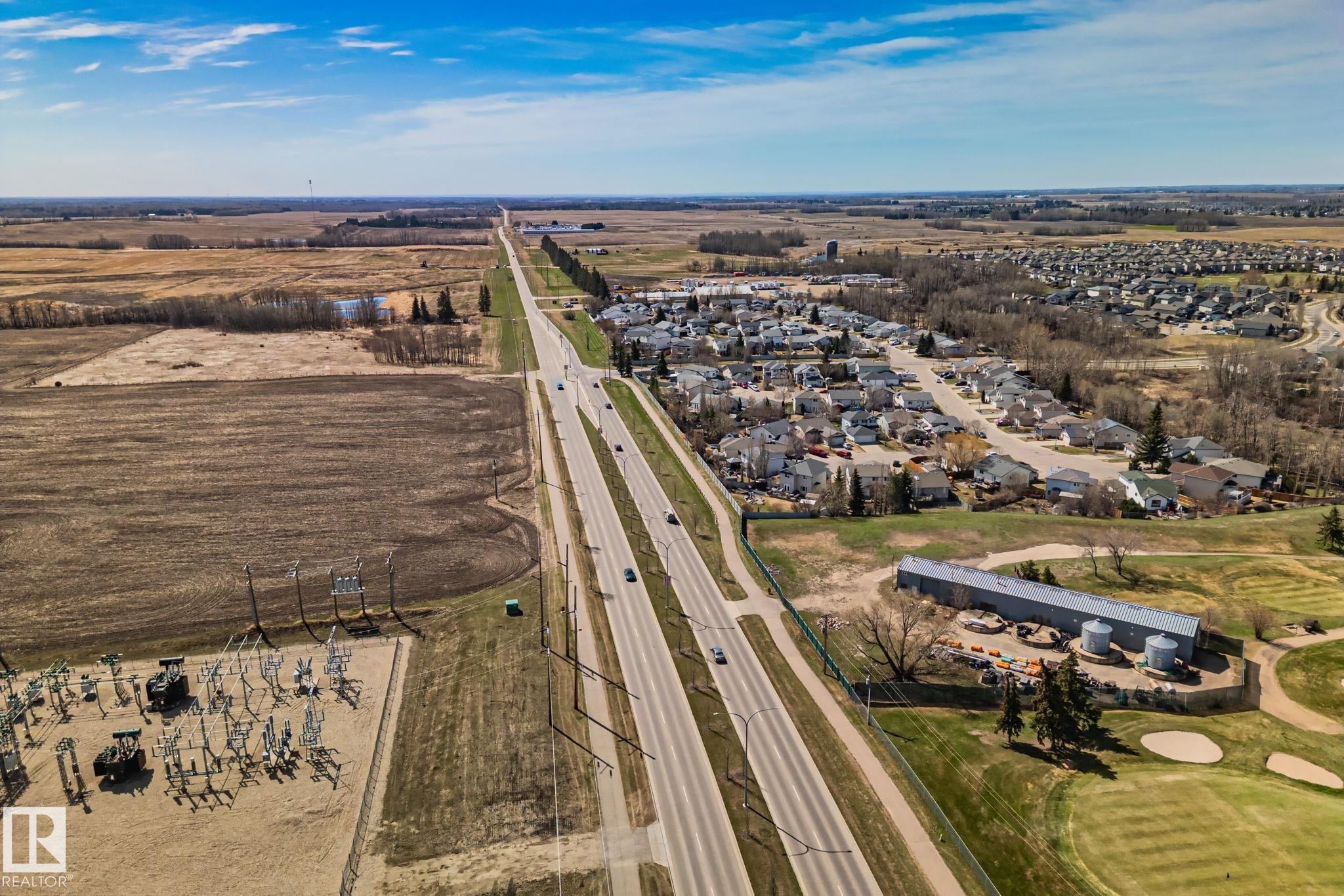 Aerial perspective showcasing a residential development alongside a multi-lane highway - 2201 Graybriar Green, Stony Plain, AB - Outdoor With View