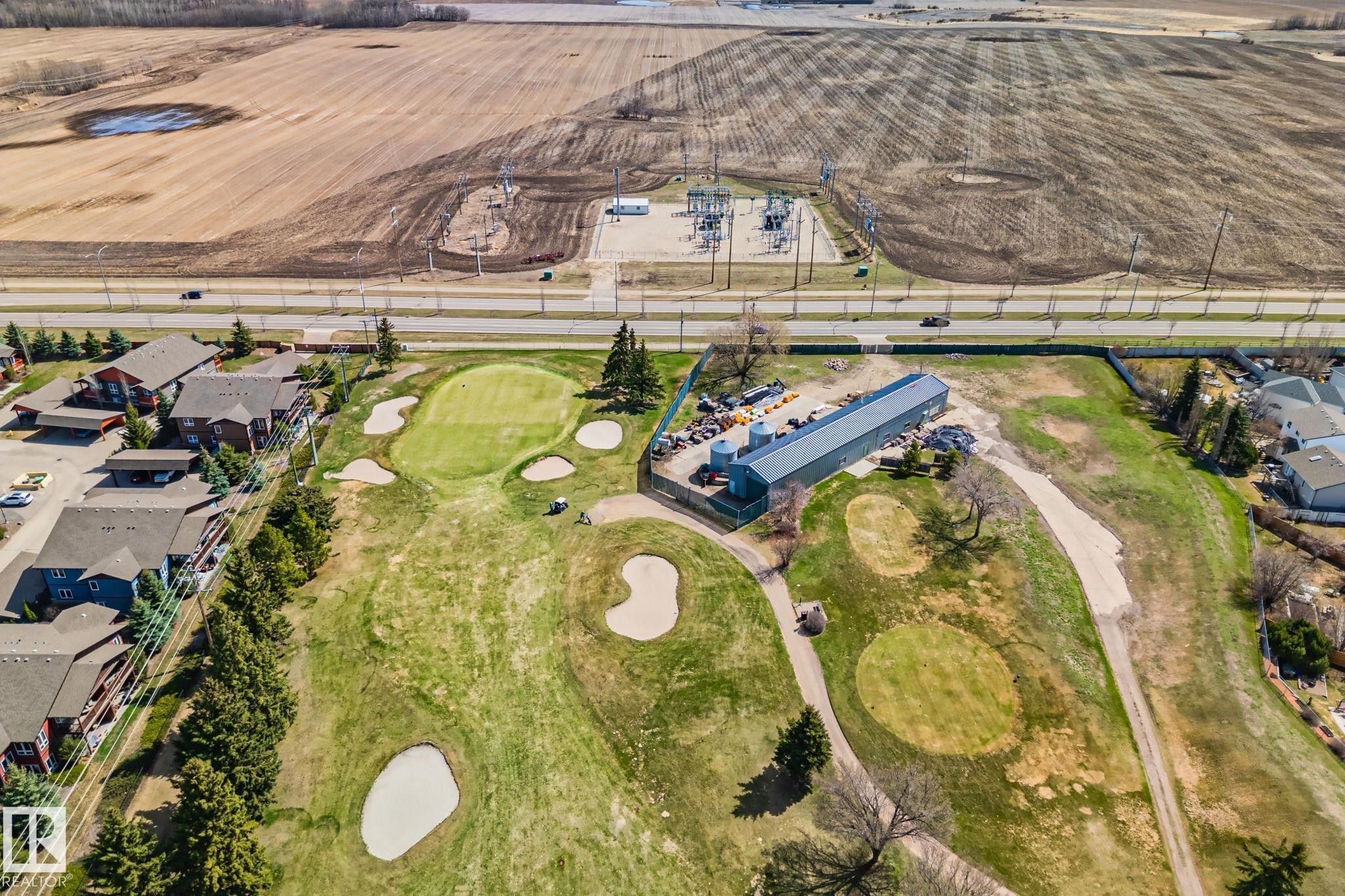 Aerial perspective showcasing a golf course with multiple greens and sand traps - 2201 Graybriar Green, Stony Plain, AB - With View