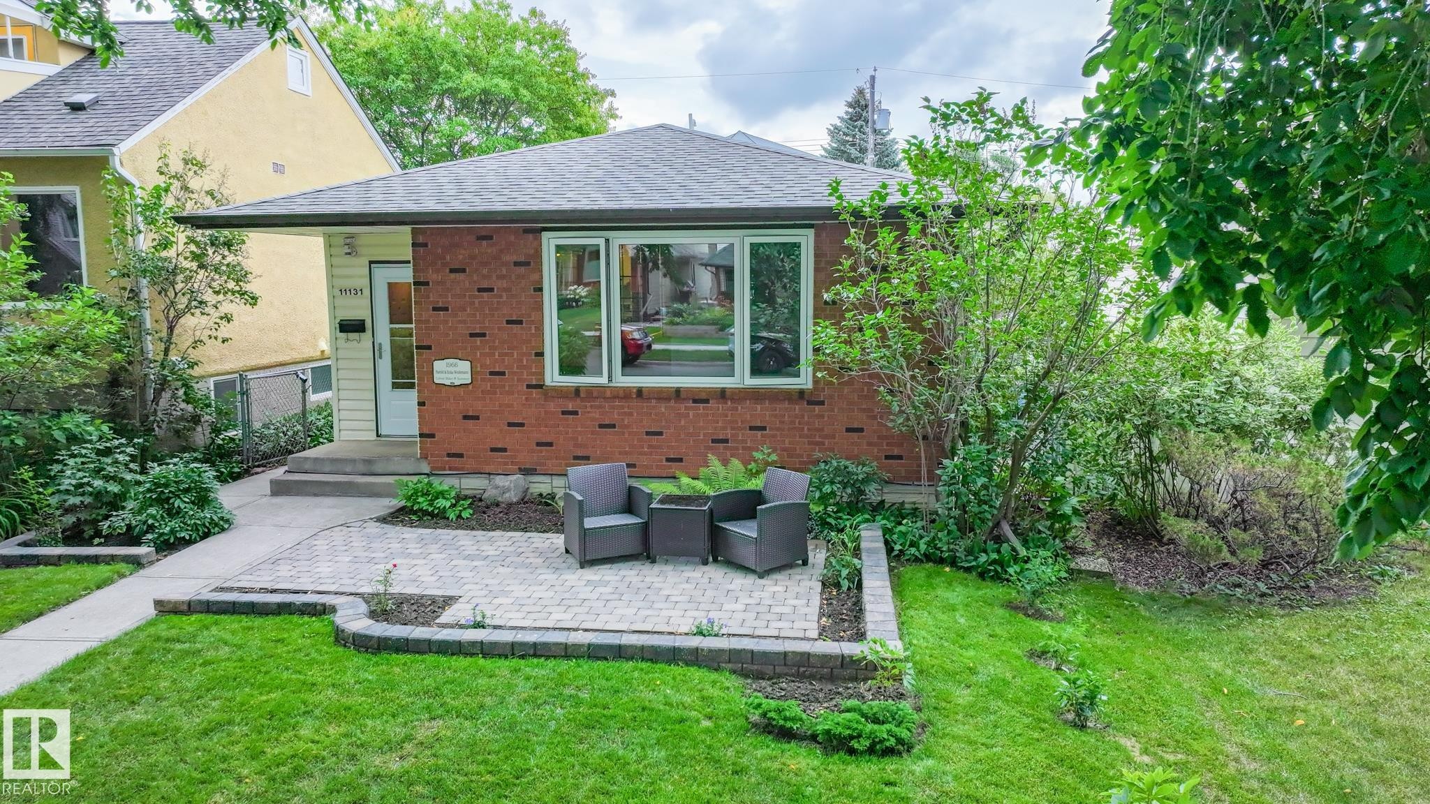 Brick facade residence with a grey shingle roof - 11131 52 Street, Edmonton, AB - Outdoor