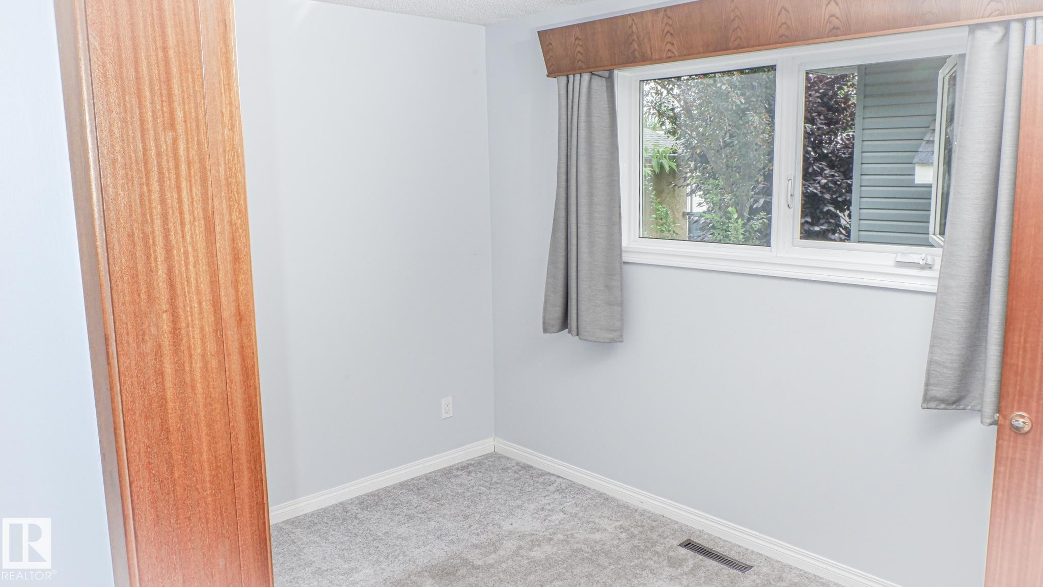 Light gray wall paint complemented by white trim - 11131 52 Street, Edmonton, AB - Indoor Photo Showing Other Room