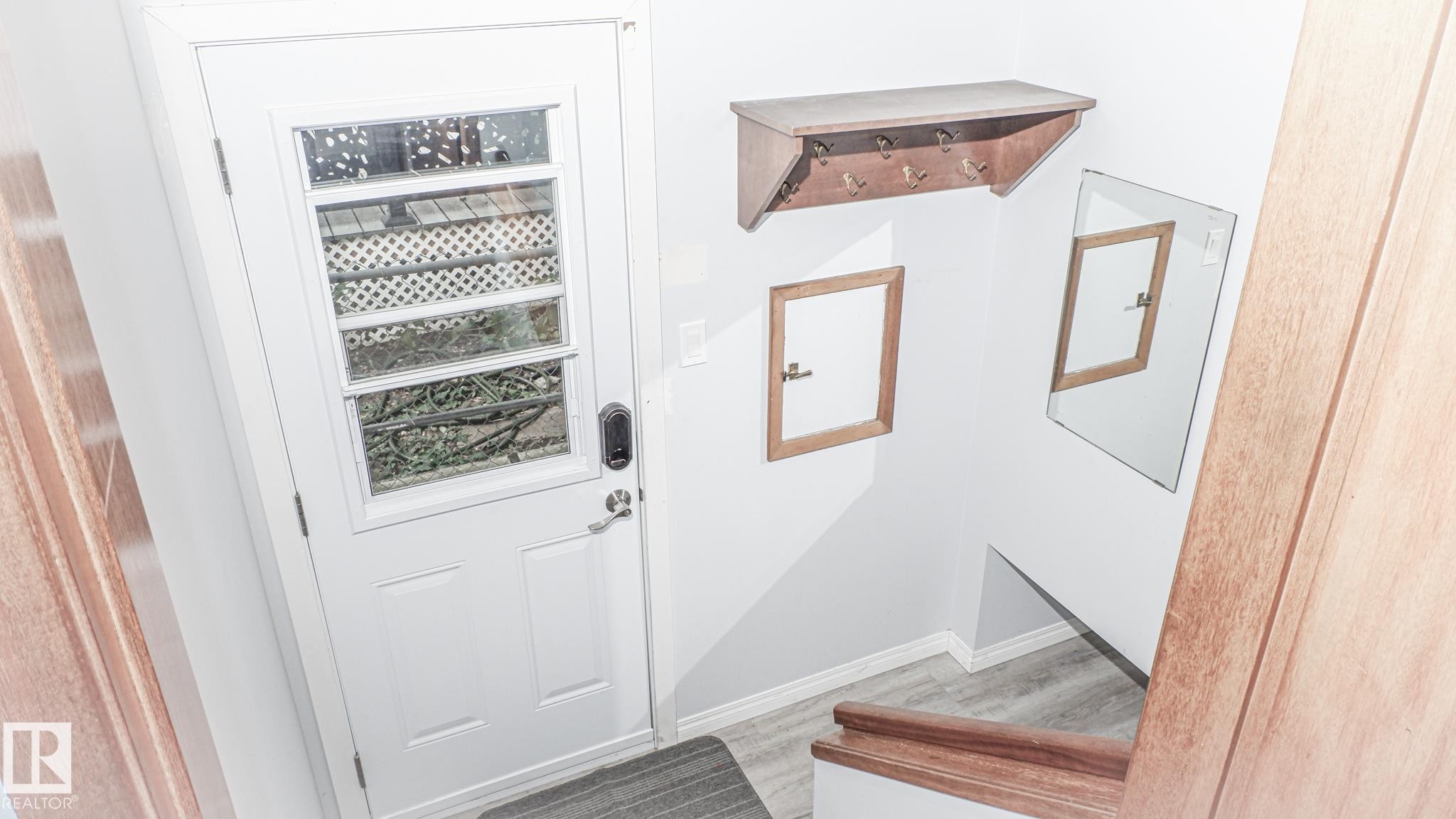 Entryway featuring a white door with multiple glass panes, a digital lock, and a matching door handle - 11131 52 Street, Edmonton, AB - Indoor Photo Showing Other Room