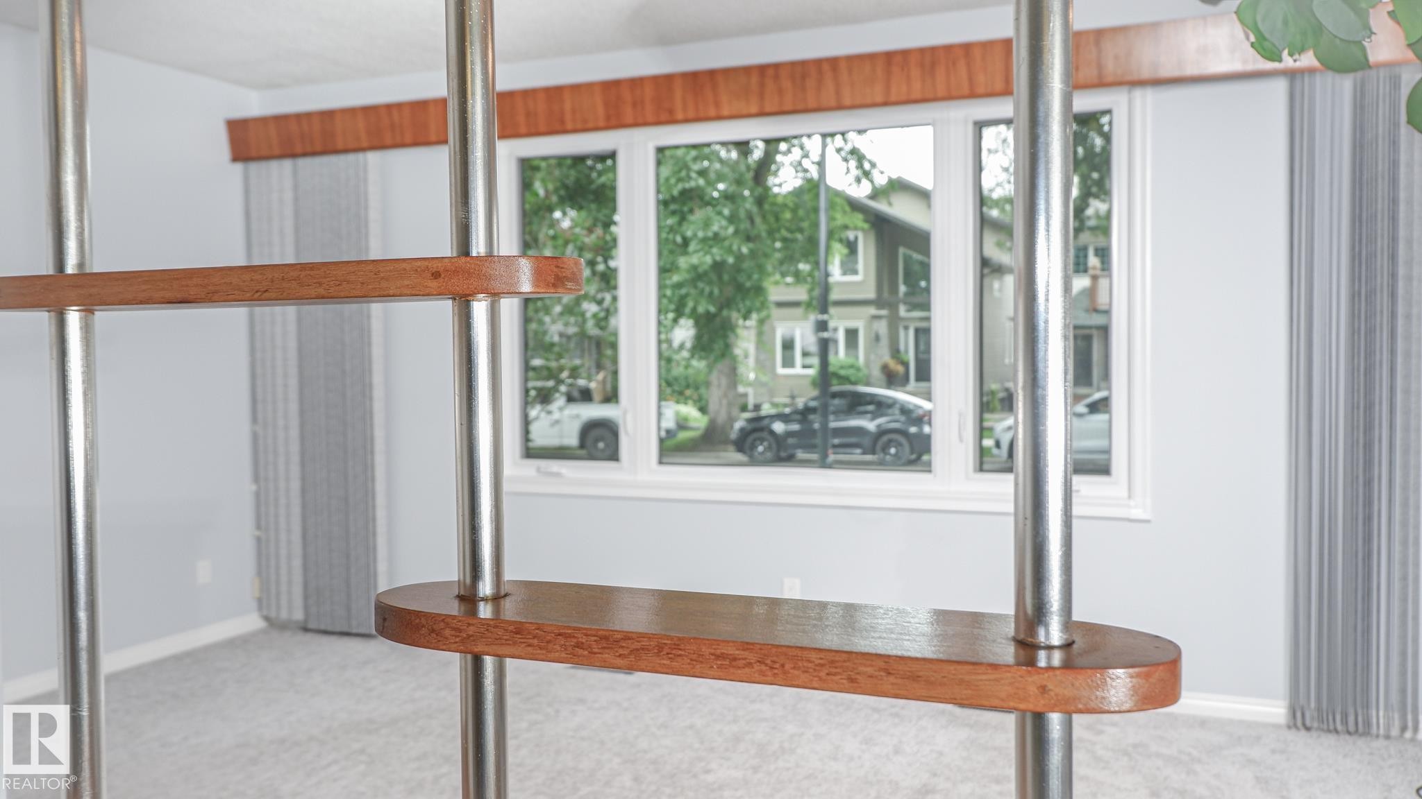 Interior space featuring a multi-pane window with wood-finish trim and vertical blinds - 11131 52 Street, Edmonton, AB - Indoor Photo Showing Other Room