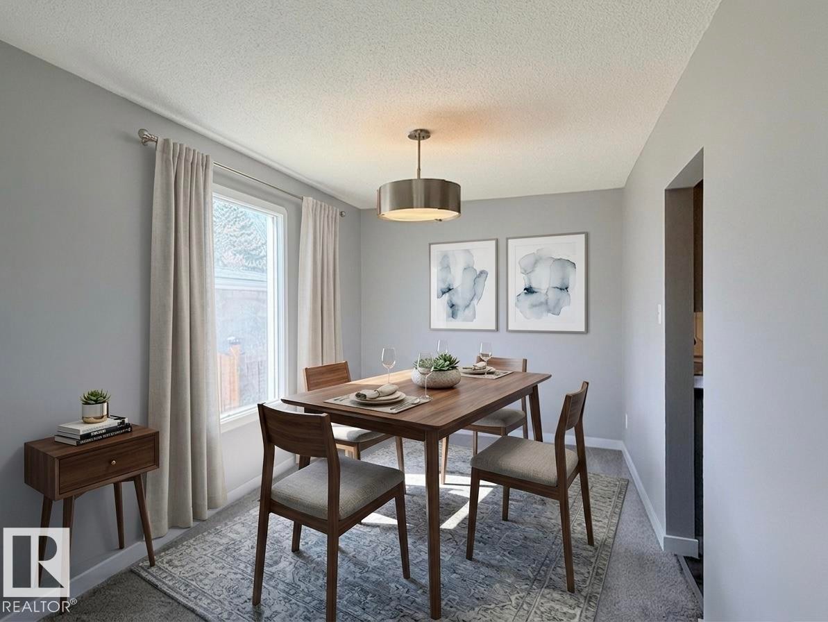 Dining area featuring a contemporary drum pendant light, a window with natural light, neutral wall paint, and carpeted flooring - 3912 108 Street, Edmonton, AB - Indoor Photo Showing Dining Room