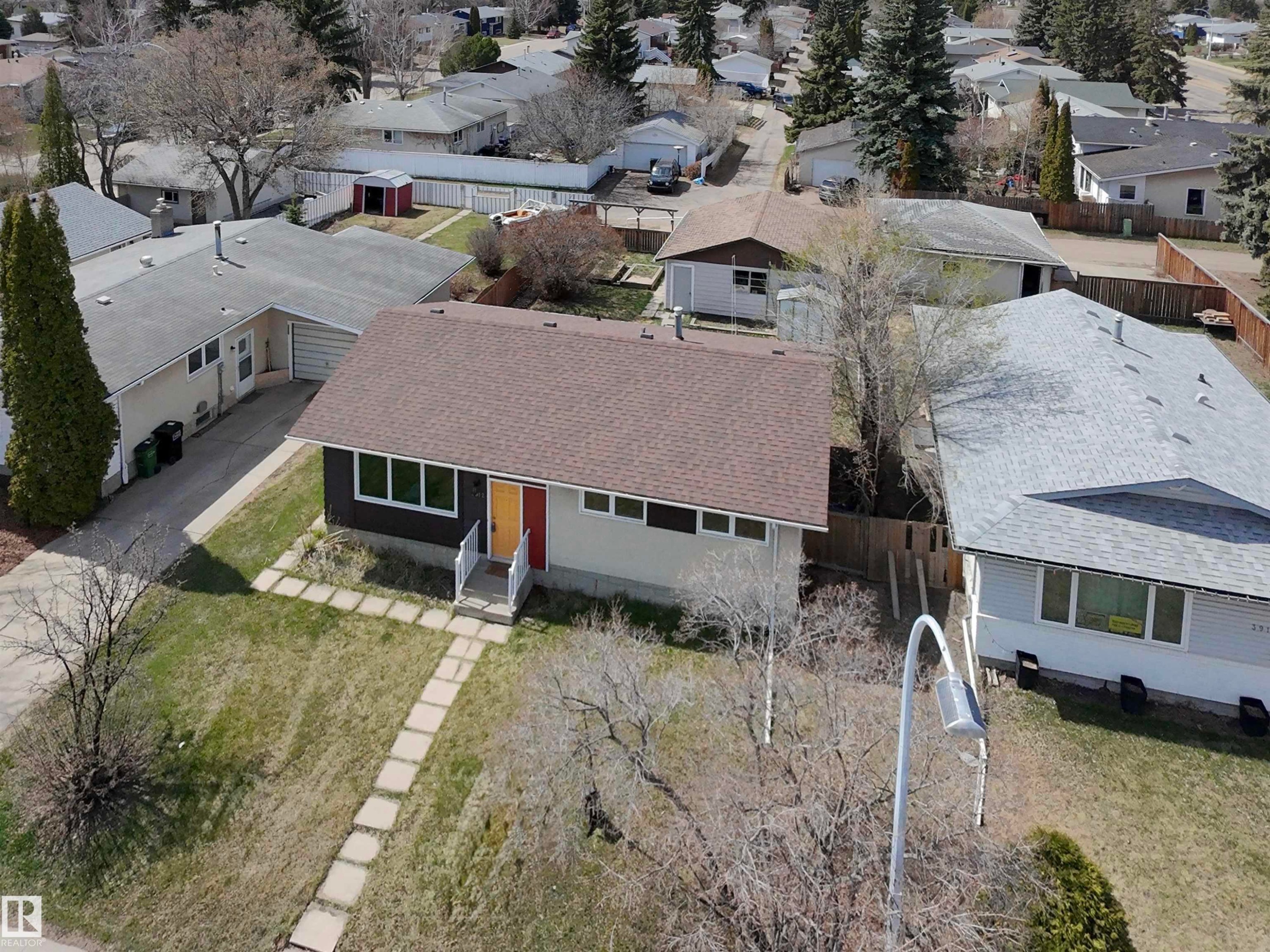 Single-story residence featuring a brown shingle roof and a light-colored facade with dark accent siding - 3912 108 Street, Edmonton, AB - Outdoor