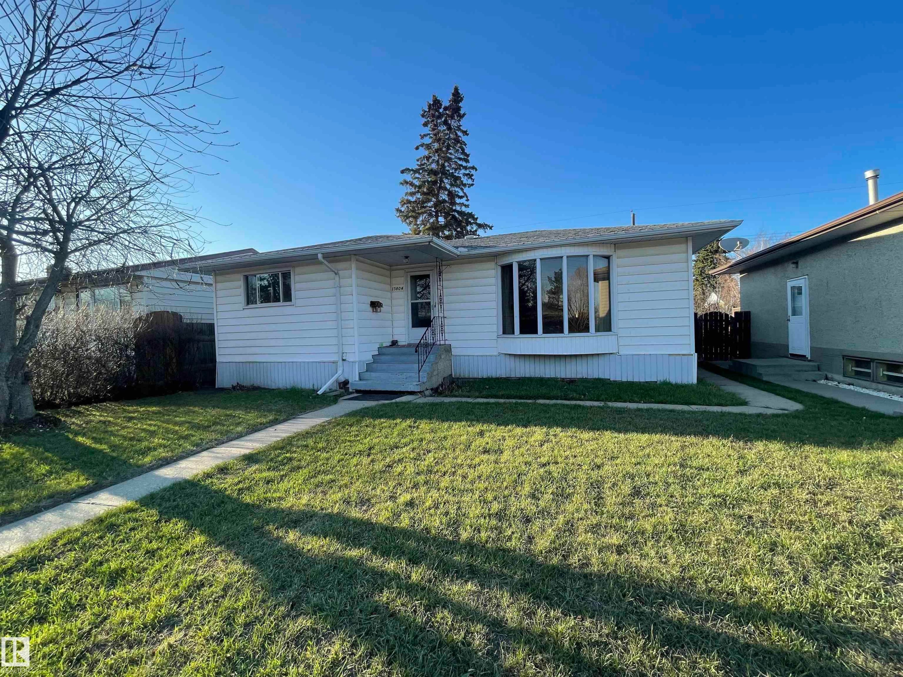 White horizontal siding exterior with a prominent bay window - 13804 132 Avenue, Edmonton, AB - Outdoor