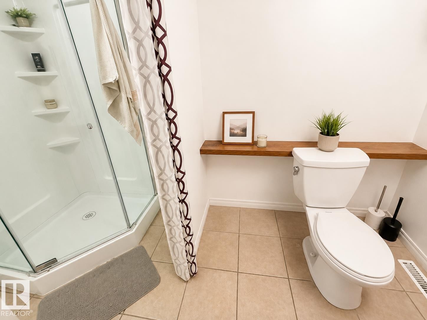 Corner shower enclosure with clear glass door, integrated shelving, and white base - 5712 101 Avenue, Edmonton, AB - Indoor Photo Showing Bathroom