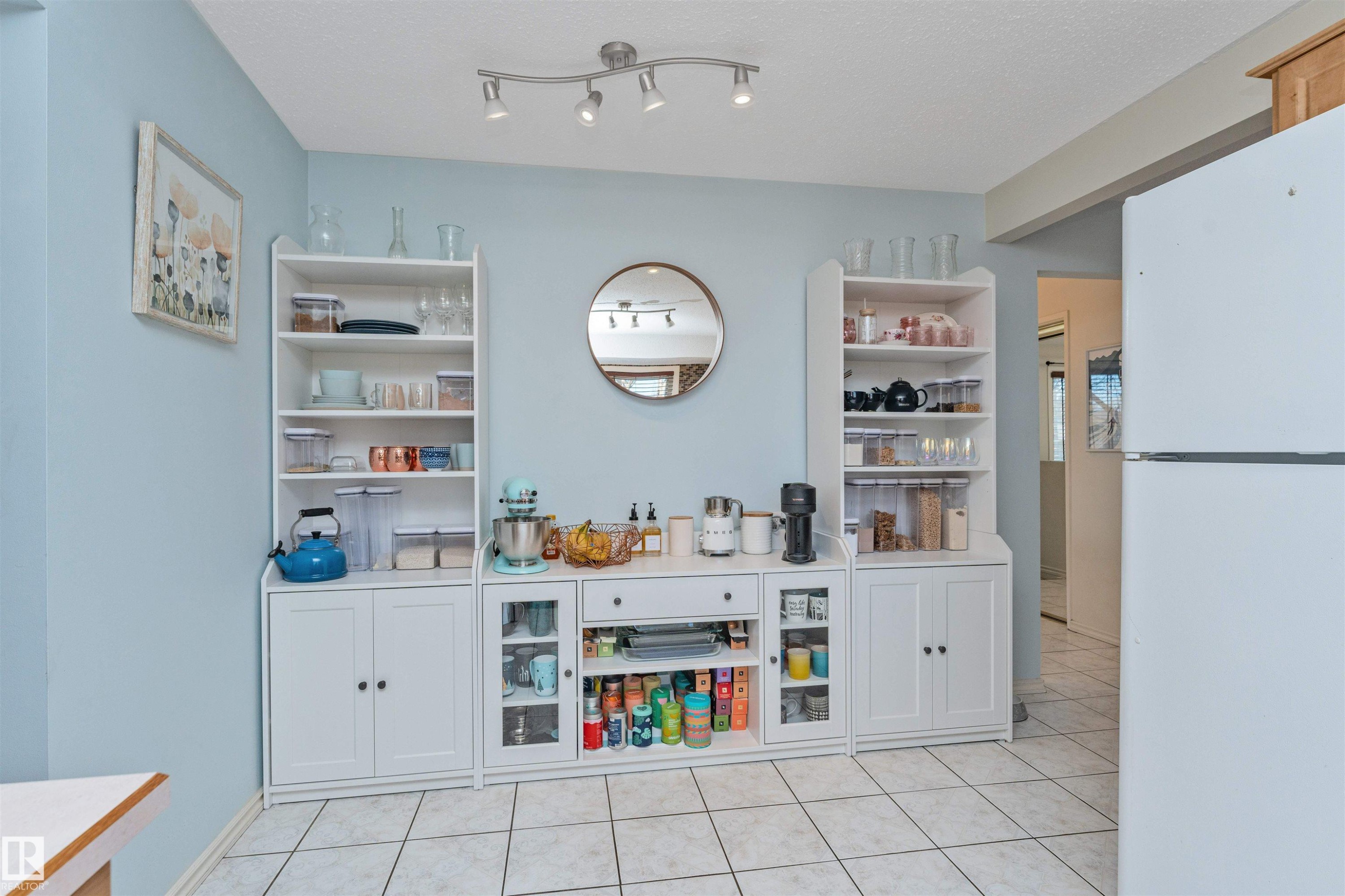 White tile flooring complements light blue wall paint - 49 Ash Crescent, St. Albert, AB - Indoor Photo Showing Other Room