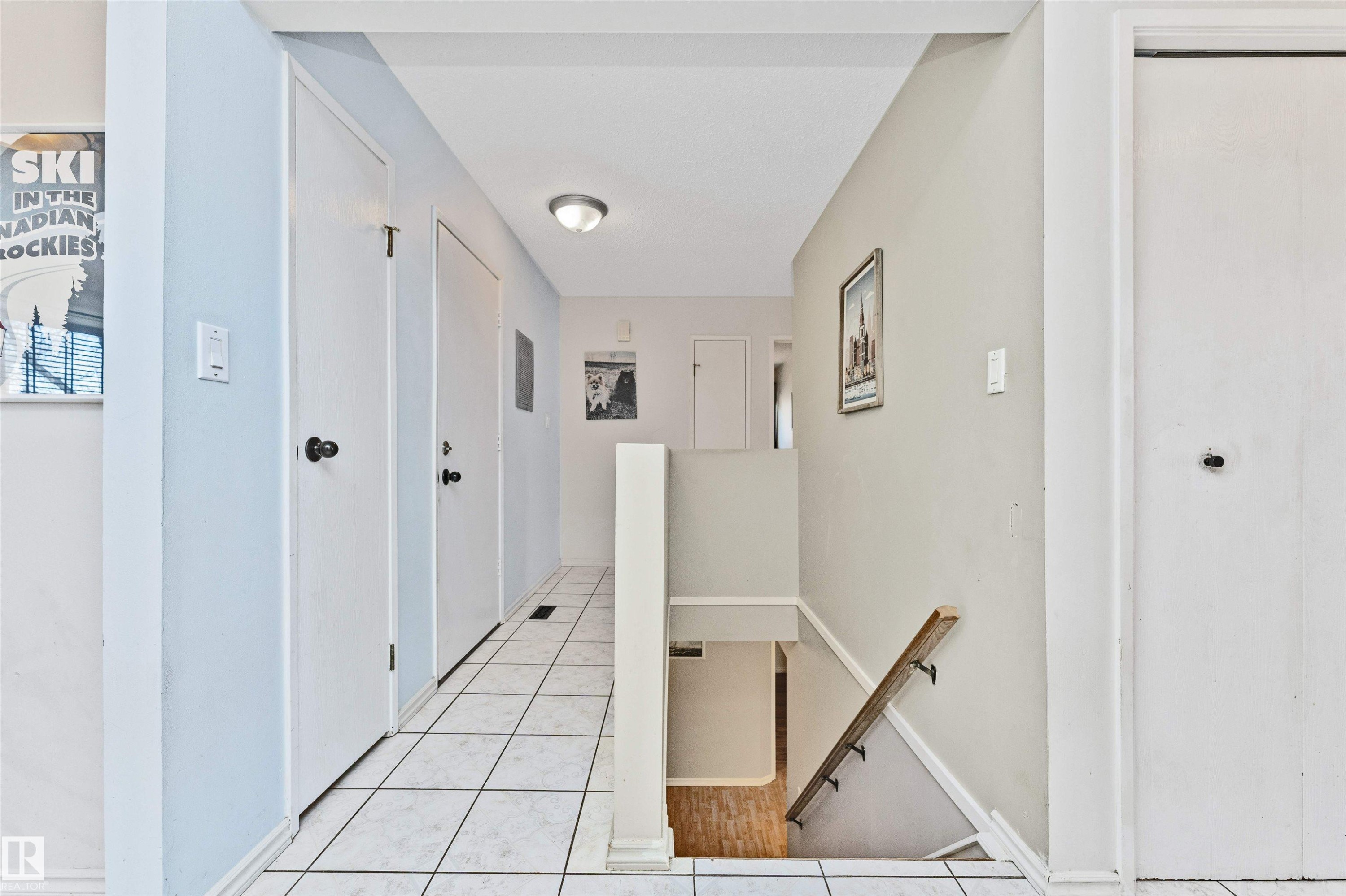 Hallway featuring square tile flooring and white trim - 49 Ash Crescent, St. Albert, AB - Indoor Photo Showing Other Room