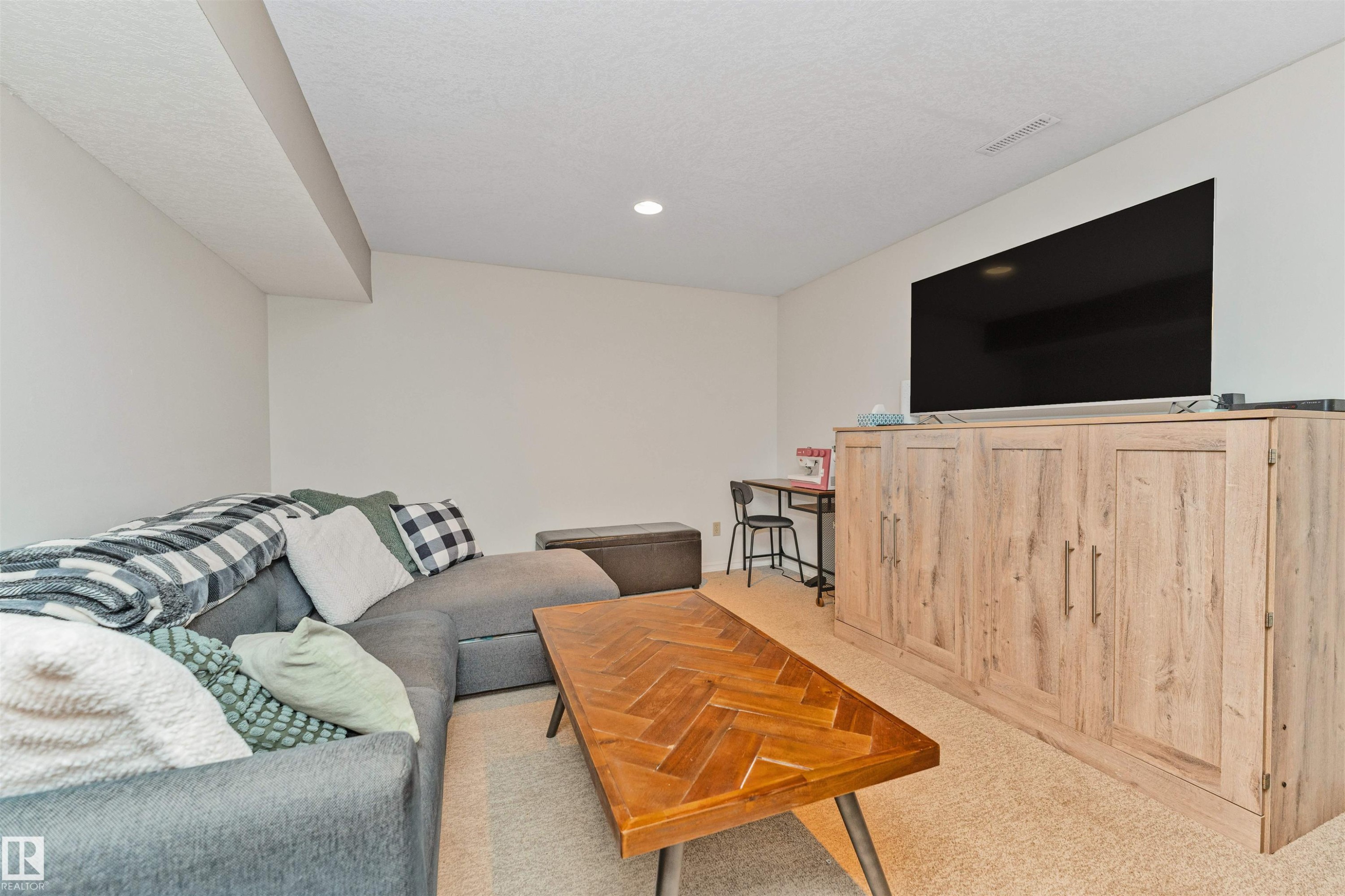 Recessed lighting illuminating a spacious room with light-toned walls and carpet flooring - 49 Ash Crescent, St. Albert, AB - Indoor