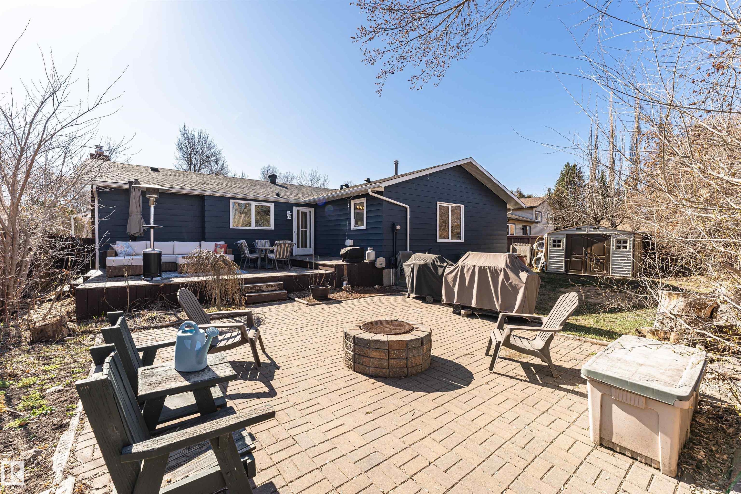 Expansive brick paver patio featuring a built-in fire pit - 49 Ash Crescent, St. Albert, AB - Outdoor With Deck Patio Veranda