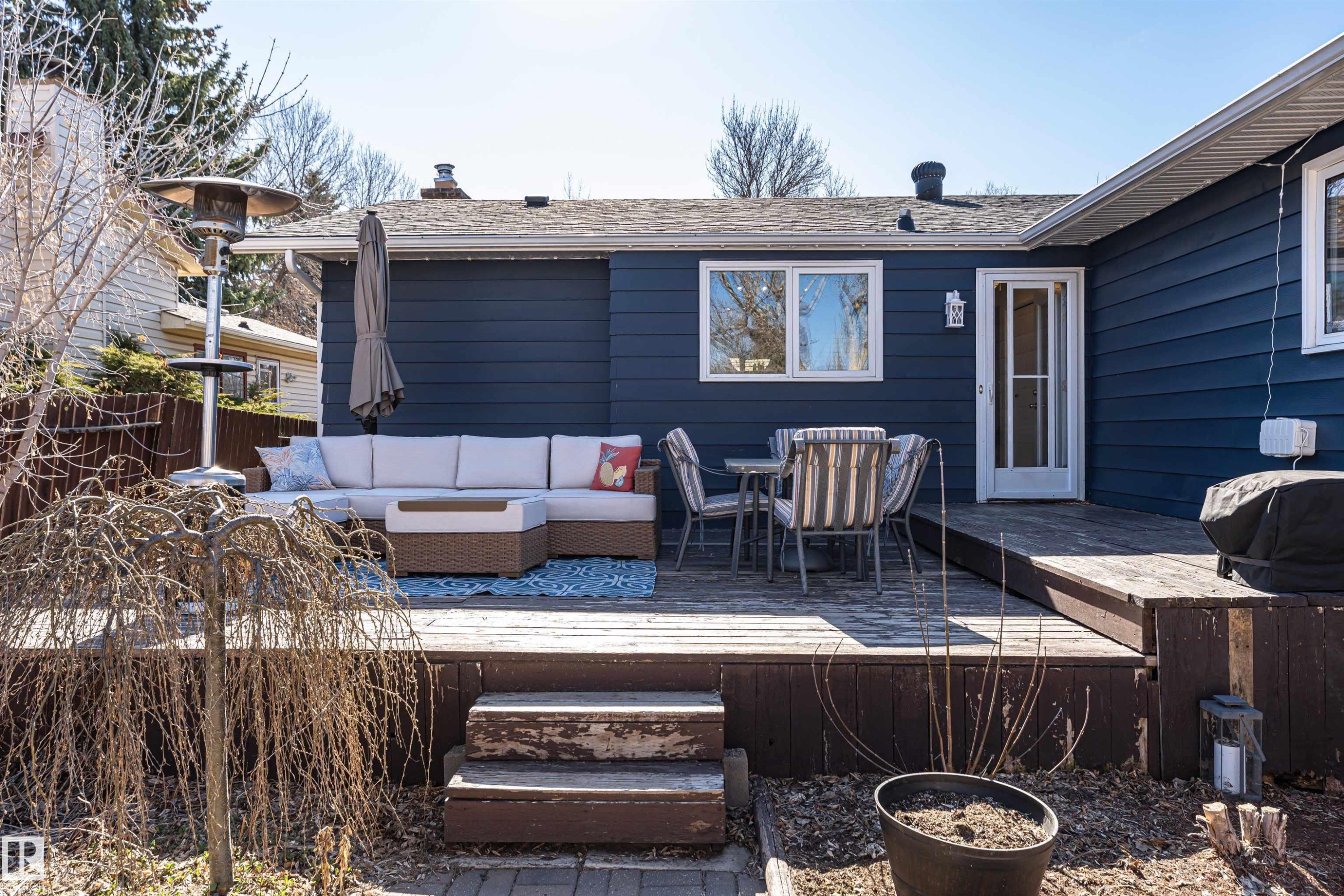 Spacious backyard deck featuring a dark wood-finish, multi-level design, and direct access to the home via a white paneled door - 49 Ash Crescent, St. Albert, AB - Outdoor With Deck Patio Veranda With Exterior