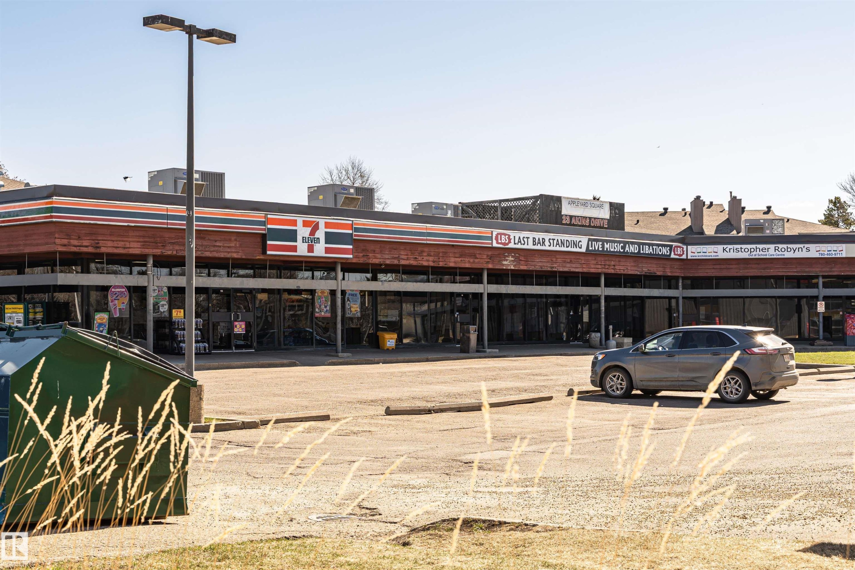 Commercial building featuring multiple storefronts with large glass windows - 49 Ash Crescent, St. Albert, AB - Outdoor