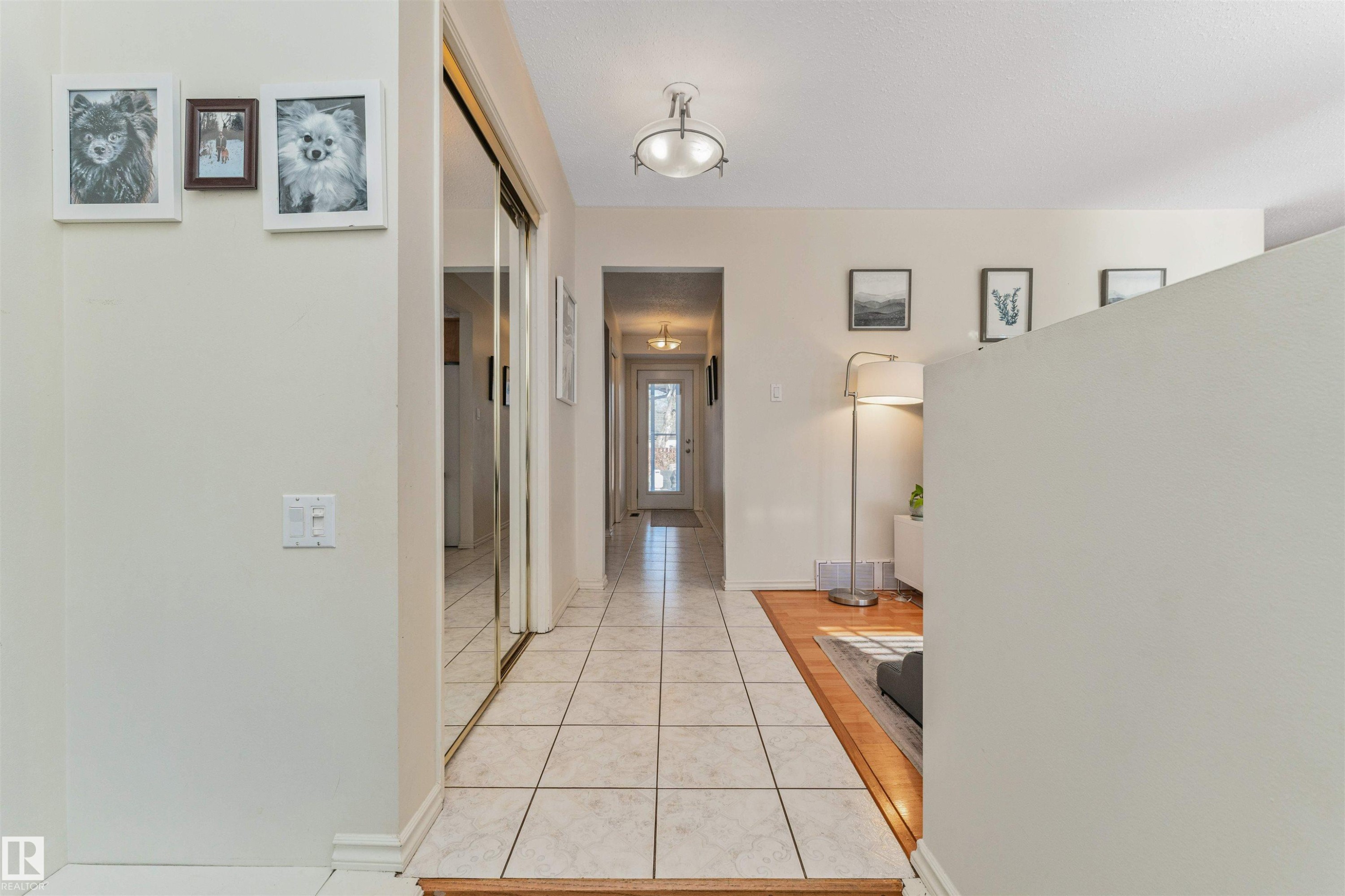Tiled entryway with mirrored closet doors and a flush-mount ceiling light fixture - 49 Ash Crescent, St. Albert, AB - Indoor Photo Showing Other Room