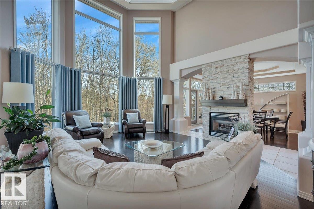 FLOOR TO CEILING WINDOWS WITH BREATHTAKING BACK YARD AND RAVINE VIEW, DUAL GAS FIREPLACE - 314 Weaver Point(E), Edmonton, AB - Indoor Photo Showing Living Room With Fireplace