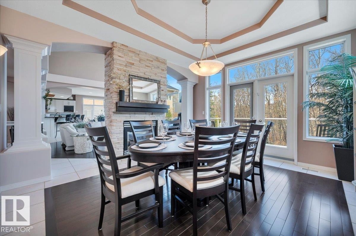 WITH HARDWOOD FLOOR INSET - 314 Weaver Point(E), Edmonton, AB - Indoor Photo Showing Dining Room With Fireplace