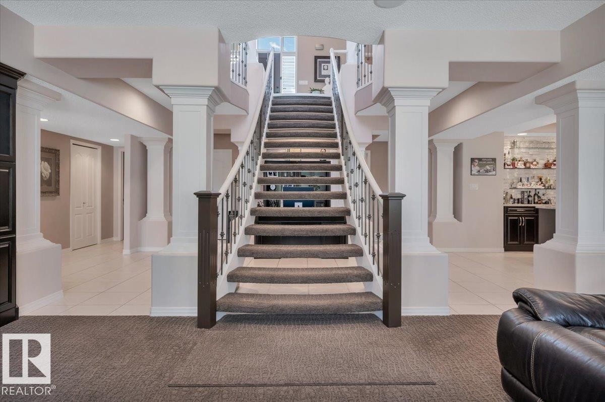 STUNNING OPEN TREAD STAIRCASE FROM THE MAIN TO LOWER LEVEL - 314 Weaver Point(E), Edmonton, AB - Indoor Photo Showing Other Room
