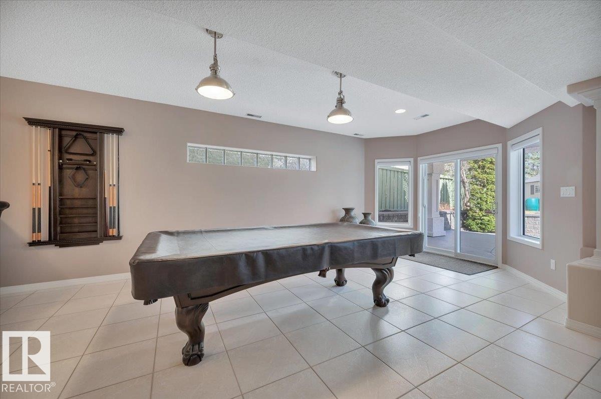 GAMES ROOM COMPLETE WITH POOL TABLE AND ACCESSORIES WITH DOOR LEADING TO THE LOWER LEVEL PATIO AND BACK YARD - 314 Weaver Point(E), Edmonton, AB - Indoor Photo Showing Other Room