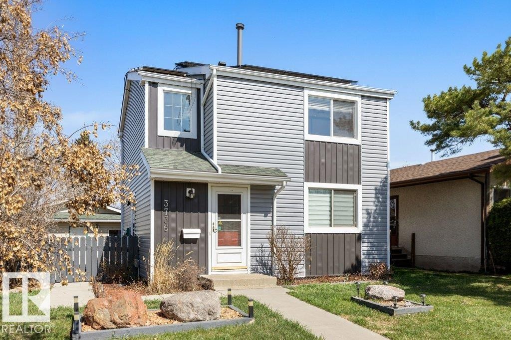 Two-story exterior featuring a gray siding facade with dark gray accent panels - 3736 12 Avenue, Edmonton, AB - Outdoor