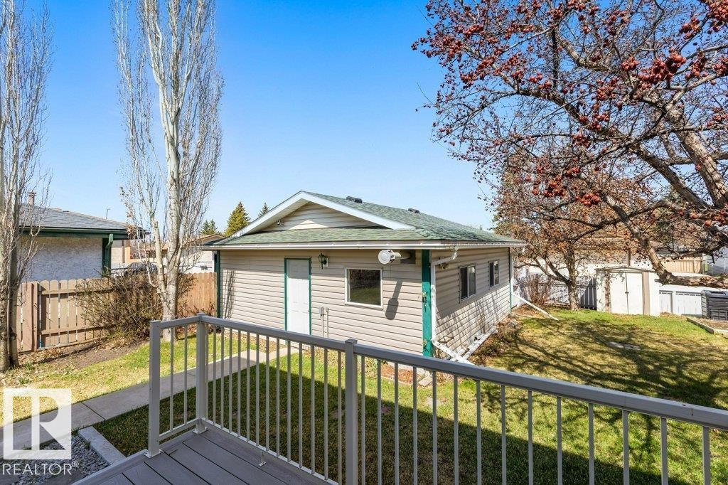 Detached garage featuring horizontal siding, a green shingle roof, and a side entry door - 3736 12 Avenue, Edmonton, AB - Outdoor