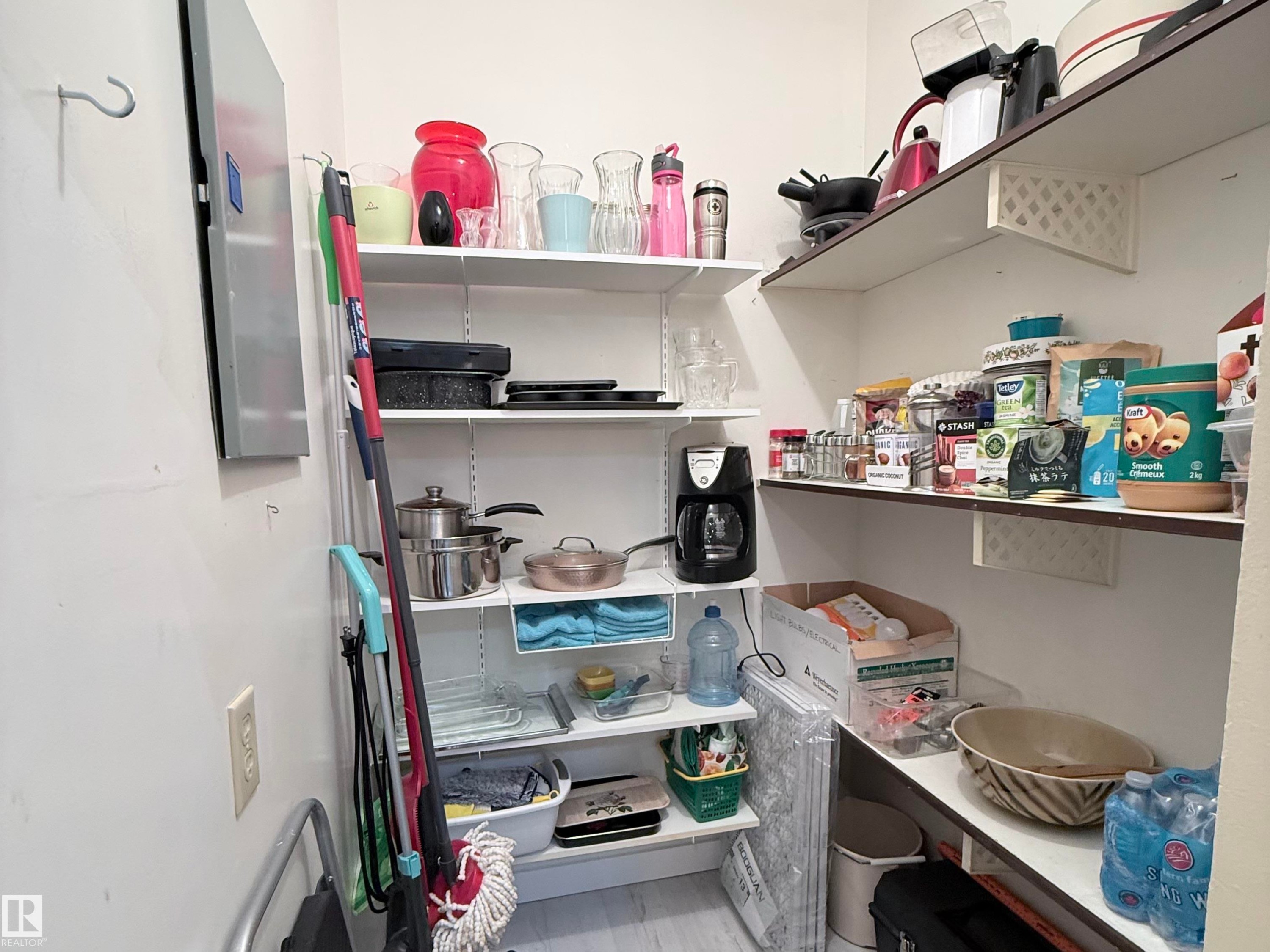Recessed pantry space featuring white wall-mounted shelving, offering ample storage - 2071 Saddleback Road, Edmonton, AB - Indoor With Storage