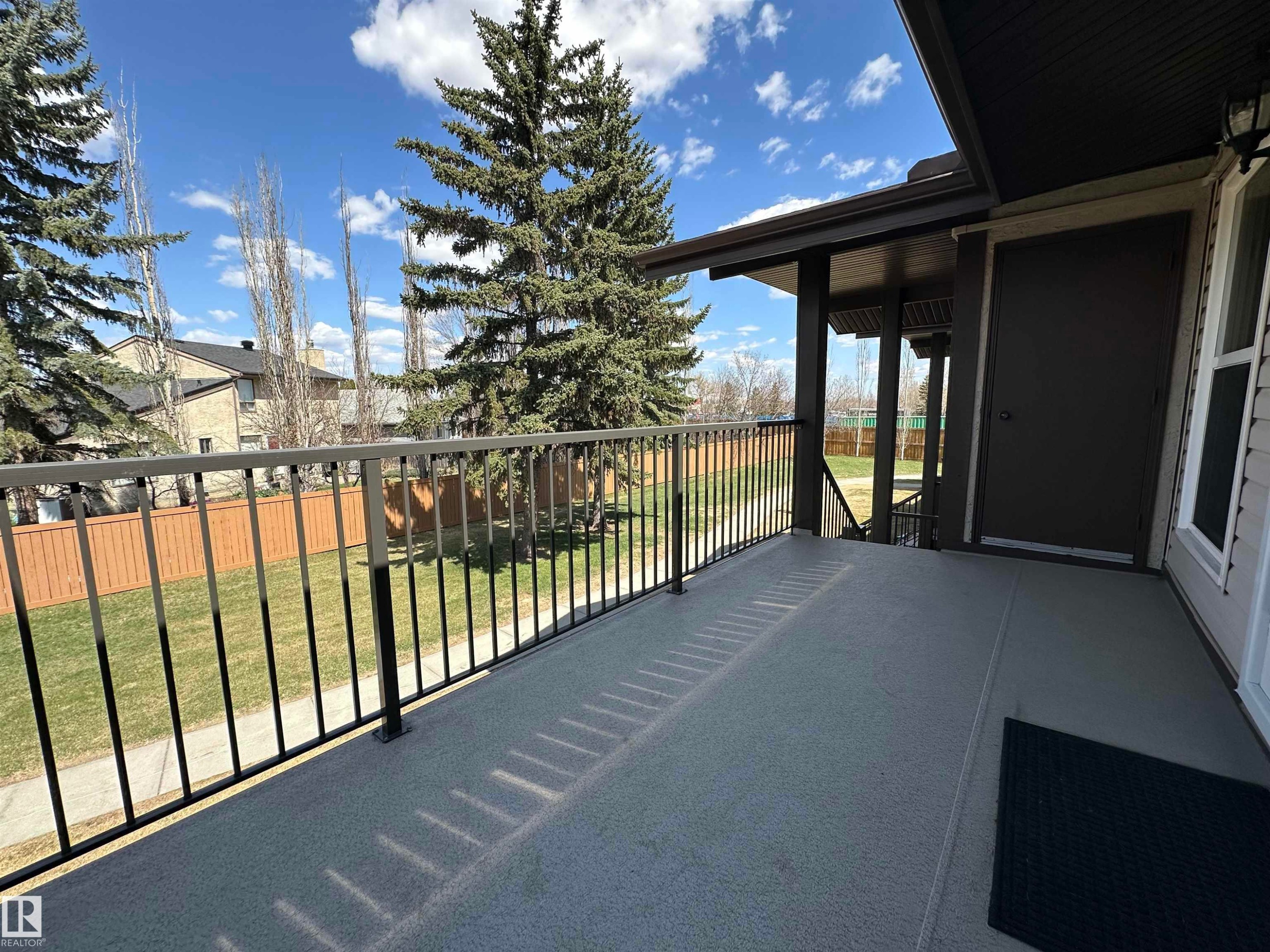 Covered balcony with textured flooring and black metal railings - 2071 Saddleback Road, Edmonton, AB - Outdoor With Exterior