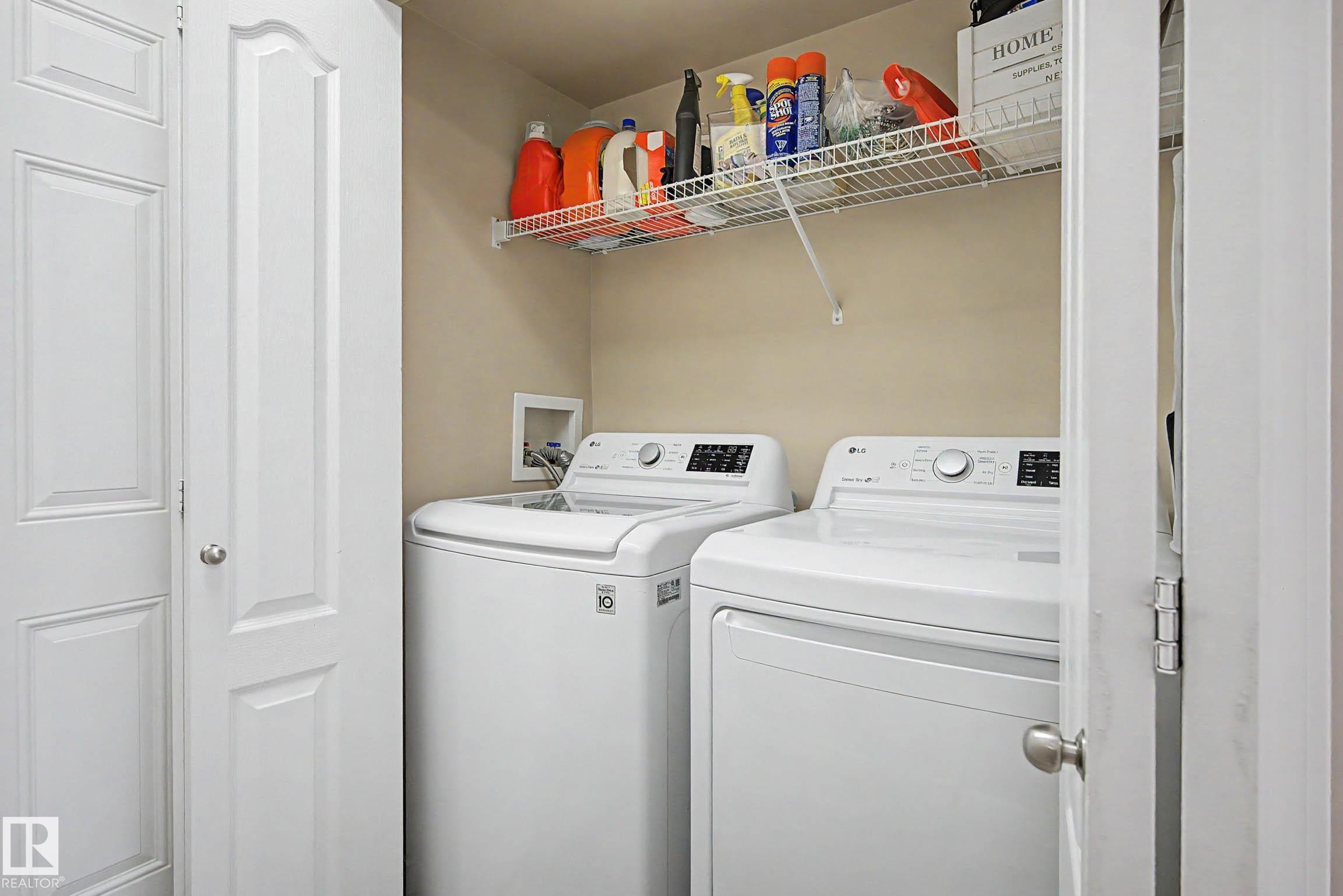 Dedicated laundry area featuring a top-load washing machine and front-load dryer - 7723 7A Avenue, Edmonton, AB - Indoor Photo Showing Laundry Room
