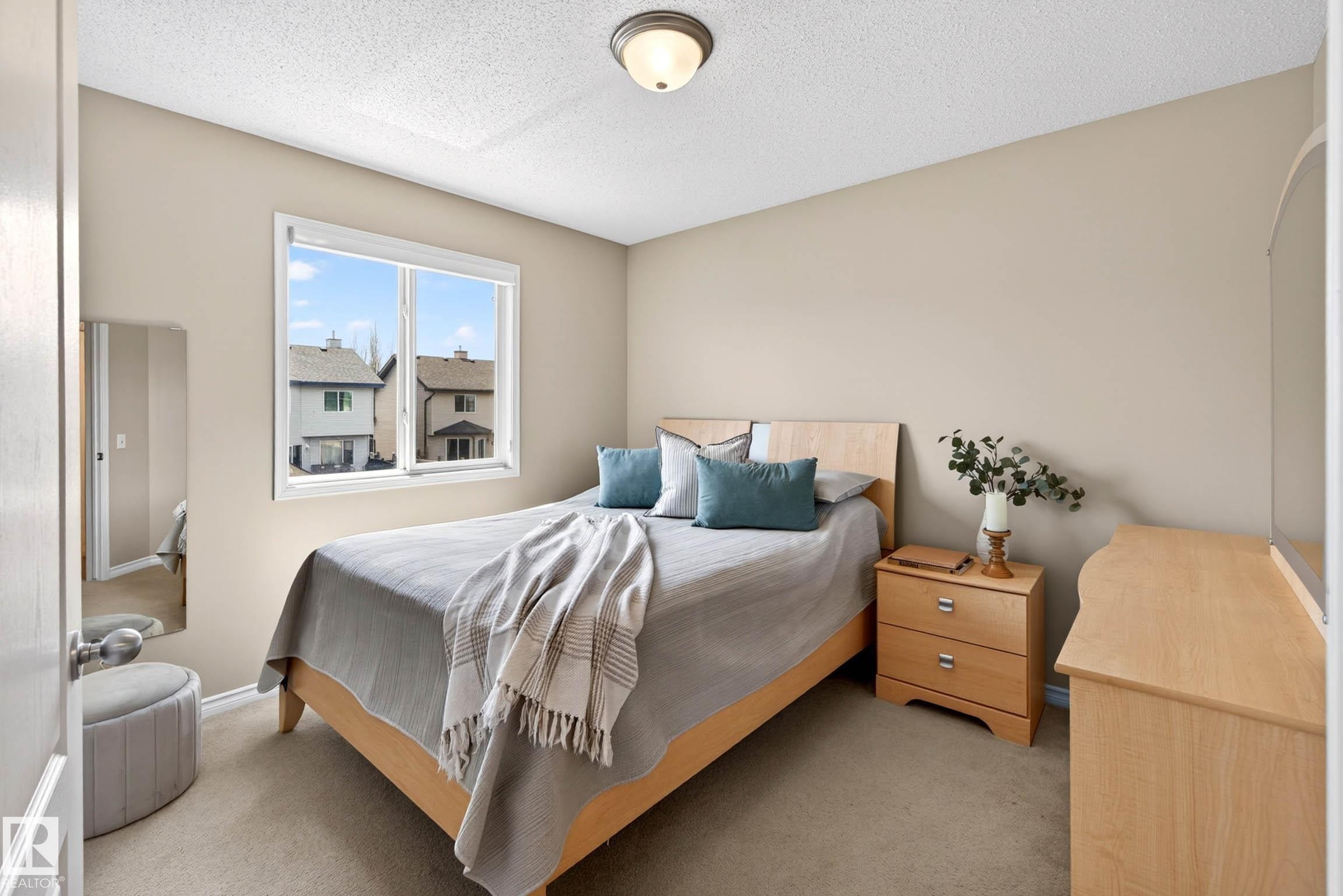 Bedroom featuring light tan walls and a single window with a white frame - 7723 7A Avenue, Edmonton, AB - Indoor Photo Showing Bedroom