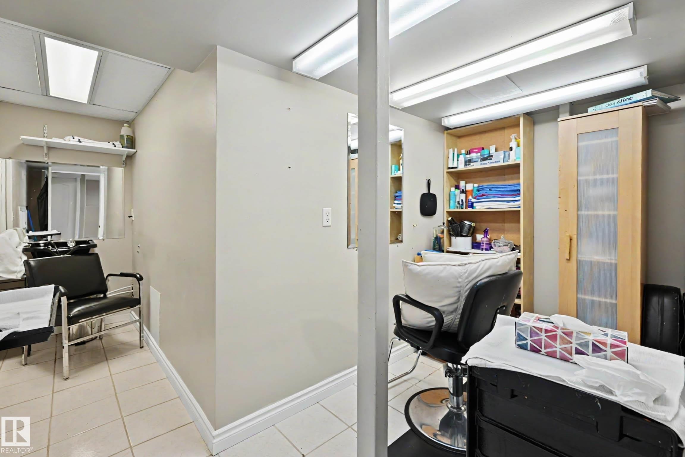 Versatile interior space featuring light-toned walls and white trim - 7723 7A Avenue, Edmonton, AB - Indoor