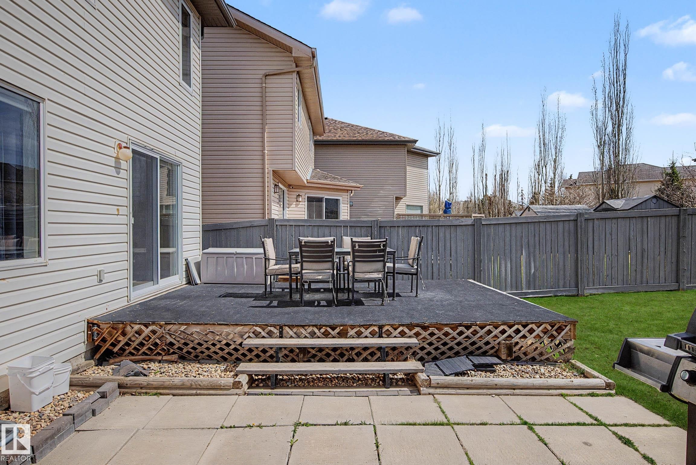 Expansive raised deck with lattice skirting and integrated stairs - 7723 7A Avenue, Edmonton, AB - Outdoor With Deck Patio Veranda
