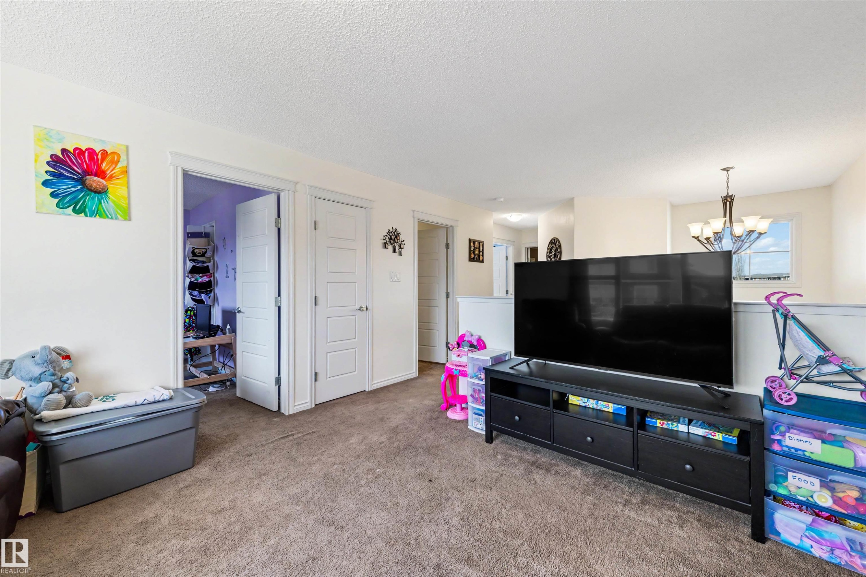 Carpeted room featuring light-toned walls, white trim, and a white ceiling - 6115 18 Avenue, Edmonton, AB - Indoor
