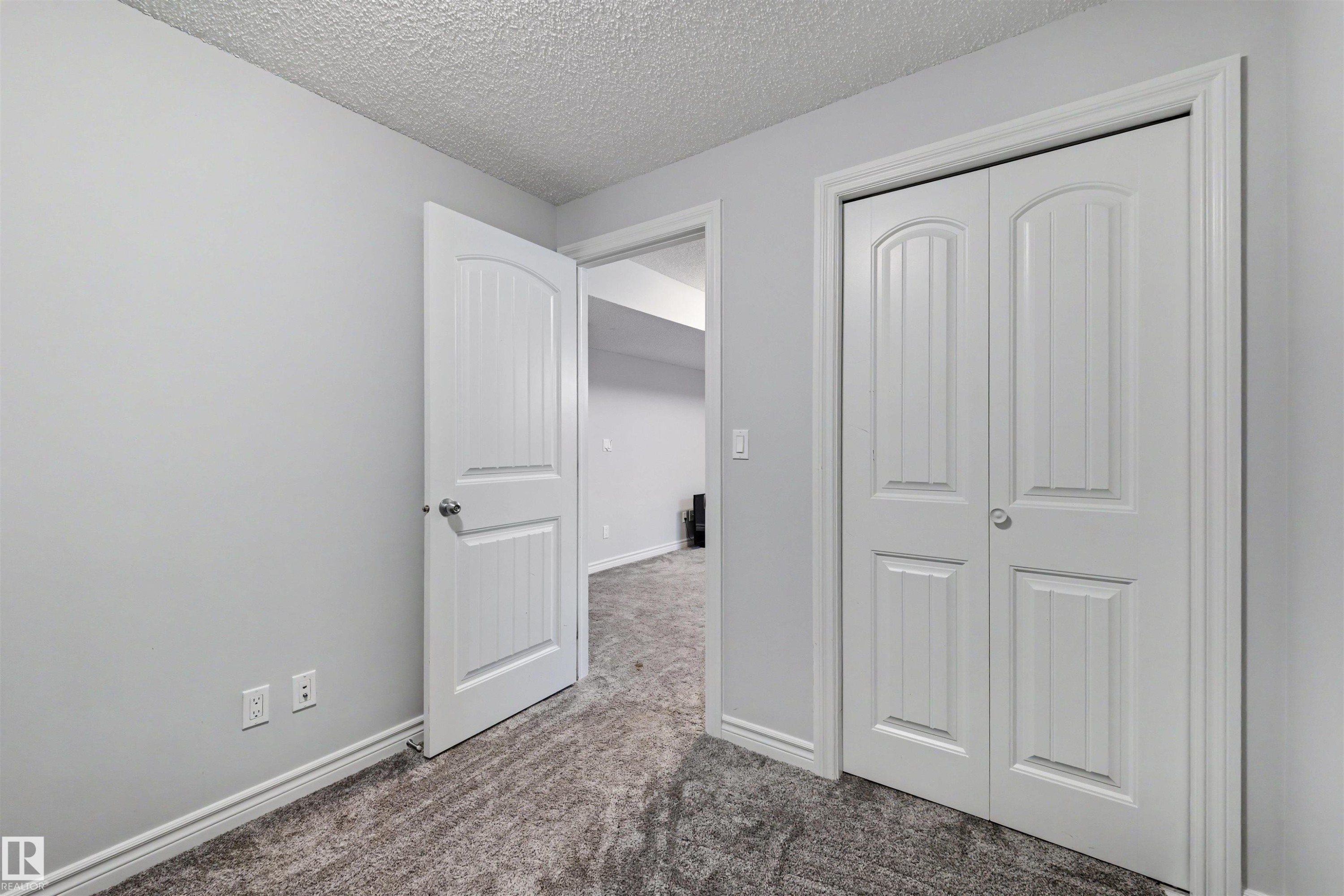 Interior room featuring light gray wall paint and textured ceiling - 6115 18 Avenue, Edmonton, AB - Indoor Photo Showing Other Room