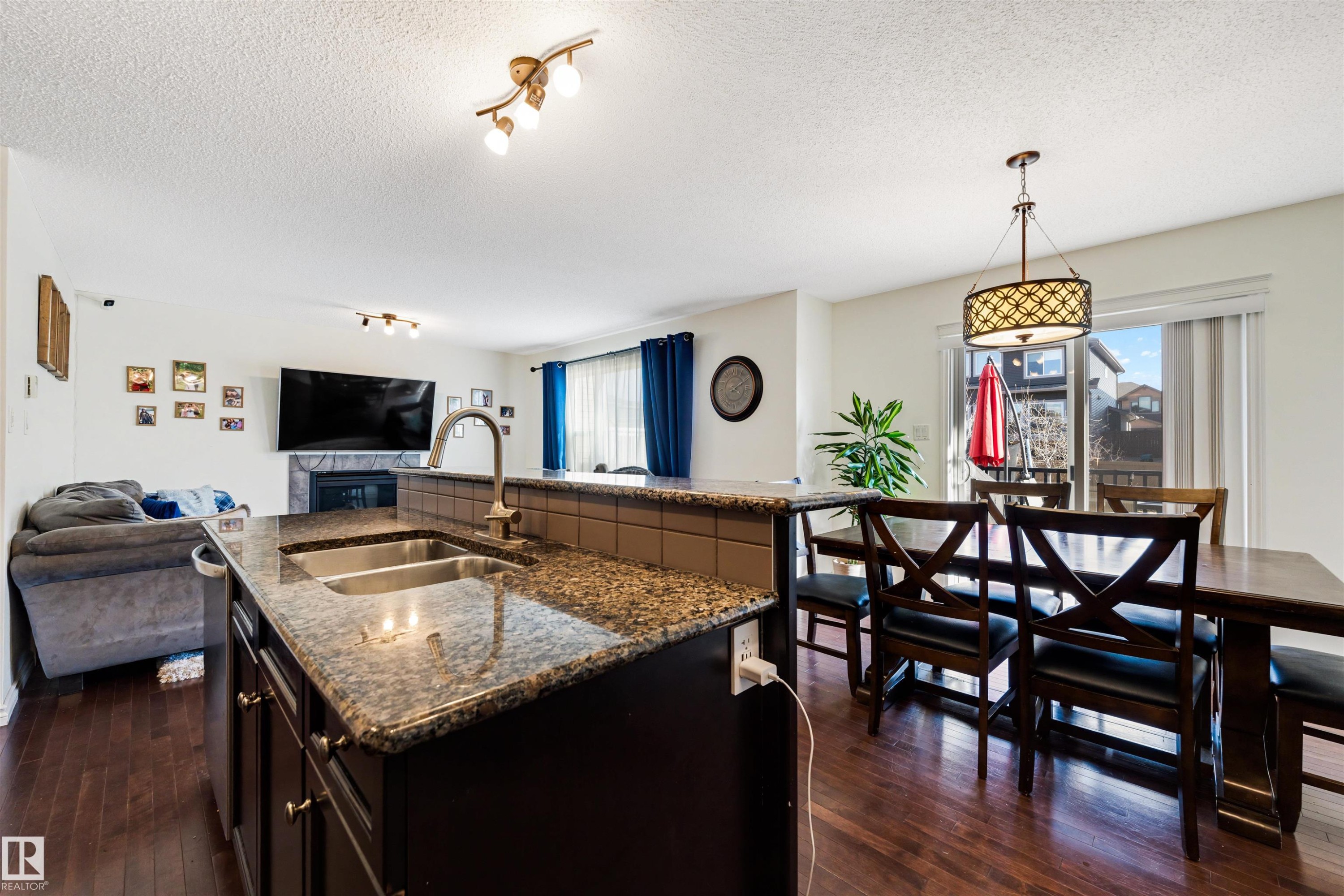 Kitchen island with a double basin sink and a high-arc faucet - 6115 18 Avenue, Edmonton, AB - Indoor