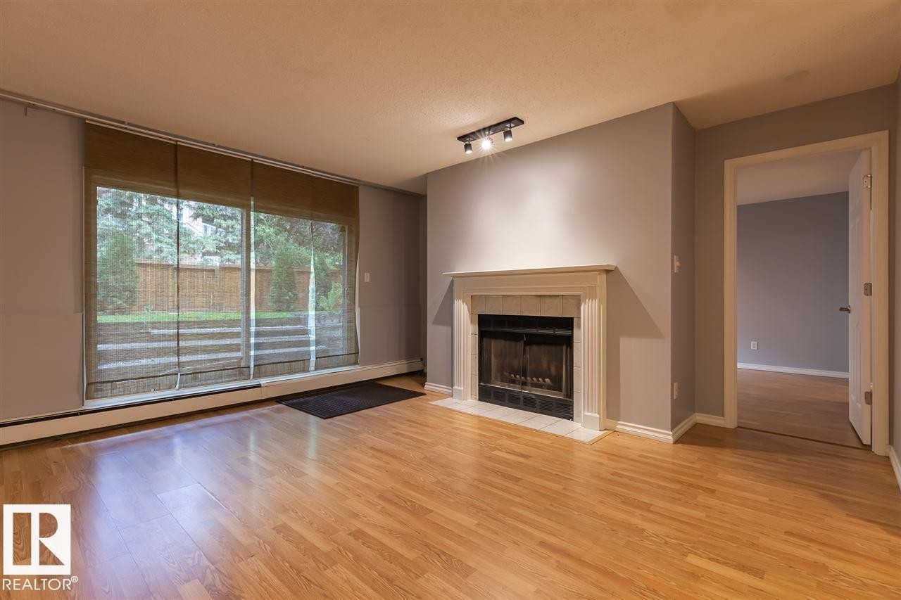 108 9010 106 Avenue, Edmonton, AB - Indoor Photo Showing Living Room With Fireplace