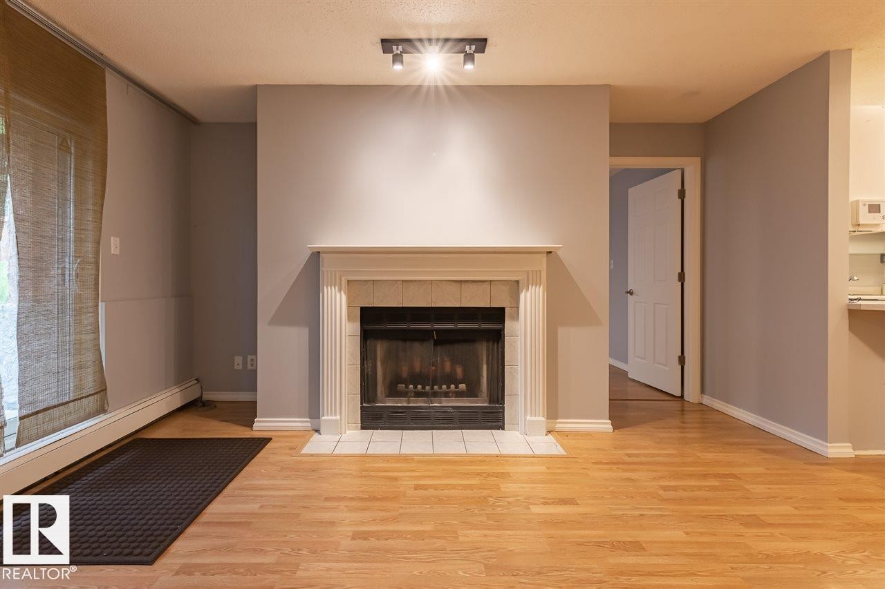 108 9010 106 Avenue, Edmonton, AB - Indoor Photo Showing Living Room With Fireplace