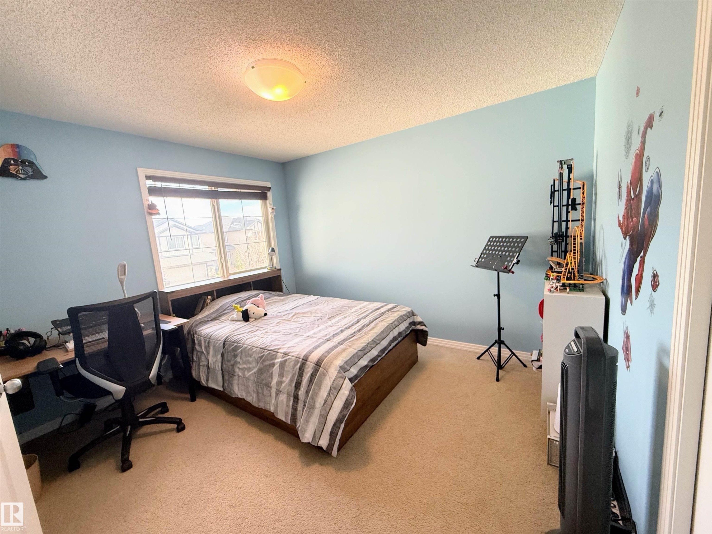 Carpeted room featuring a double window with blinds, light blue walls, and a ceiling-mounted light fixture - 3538 Claxton Crescent, Edmonton, AB - Indoor Photo Showing Bedroom