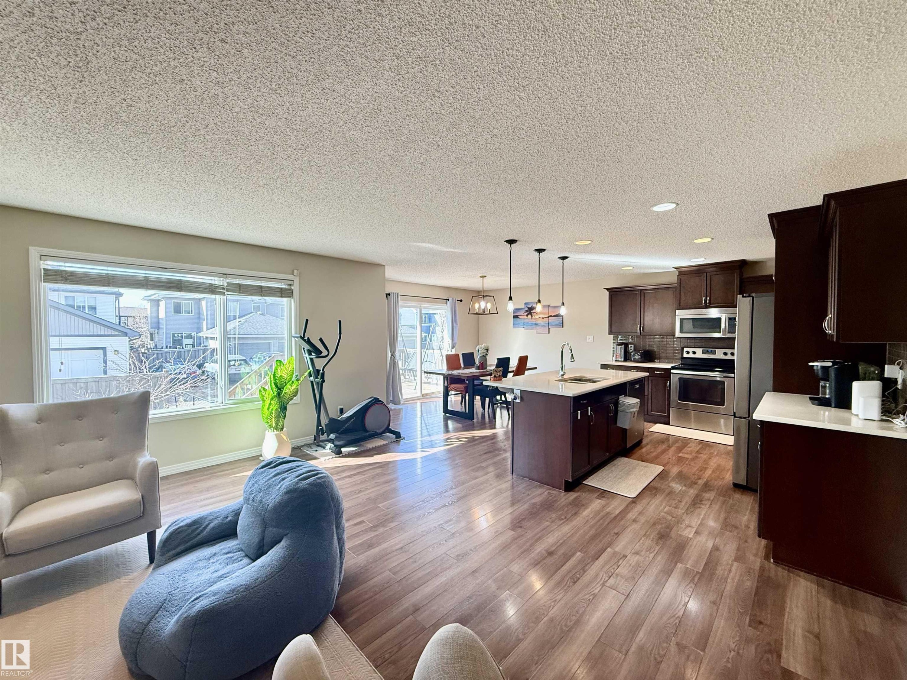 Open-concept main living area with wood-finish flooring - 3538 Claxton Crescent, Edmonton, AB - Indoor