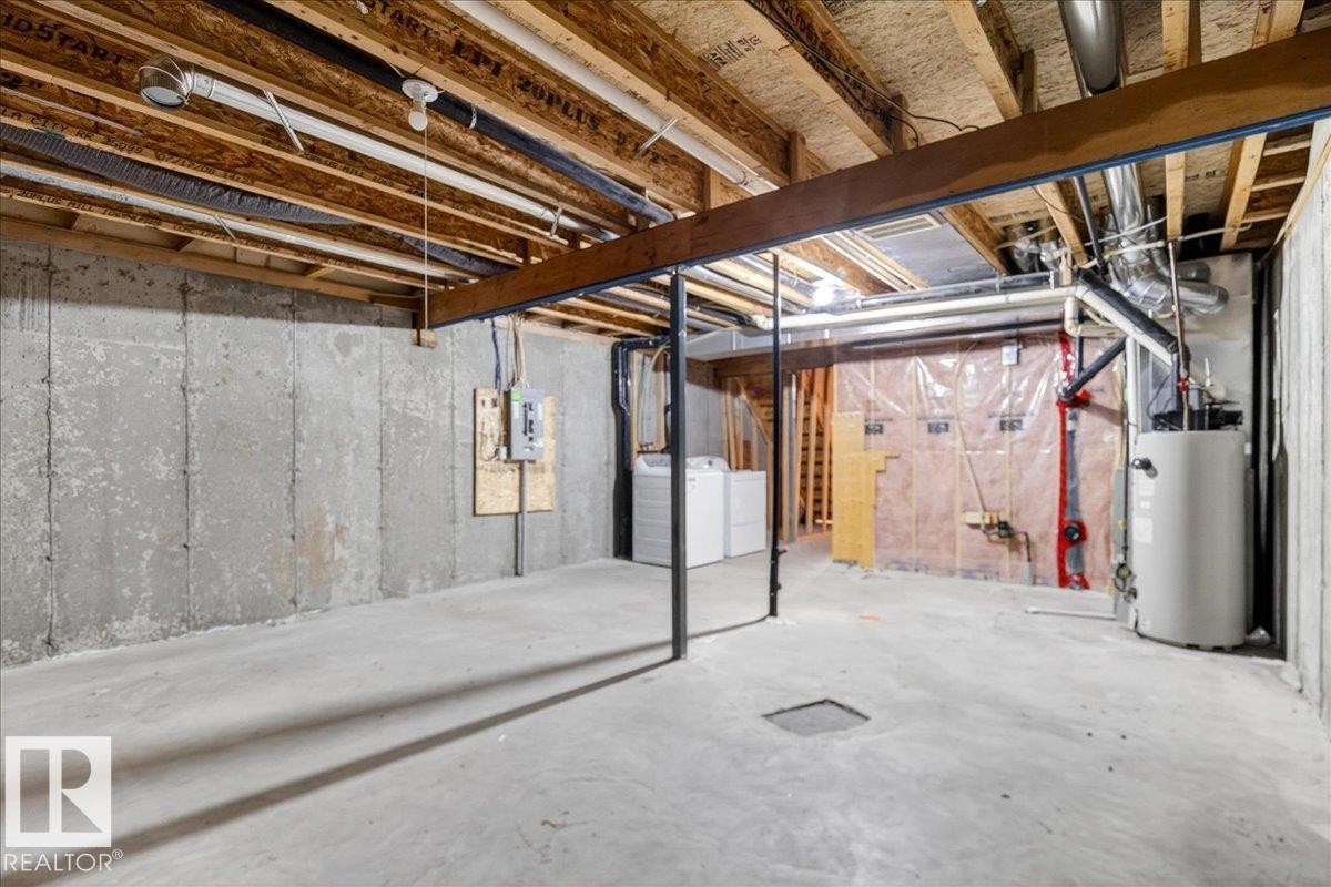 Unfinished basement featuring concrete walls and flooring, exposed ceiling joists, and a water heater - #7 18004 89 St Nw, Edmonton, AB - Indoor Photo Showing Basement