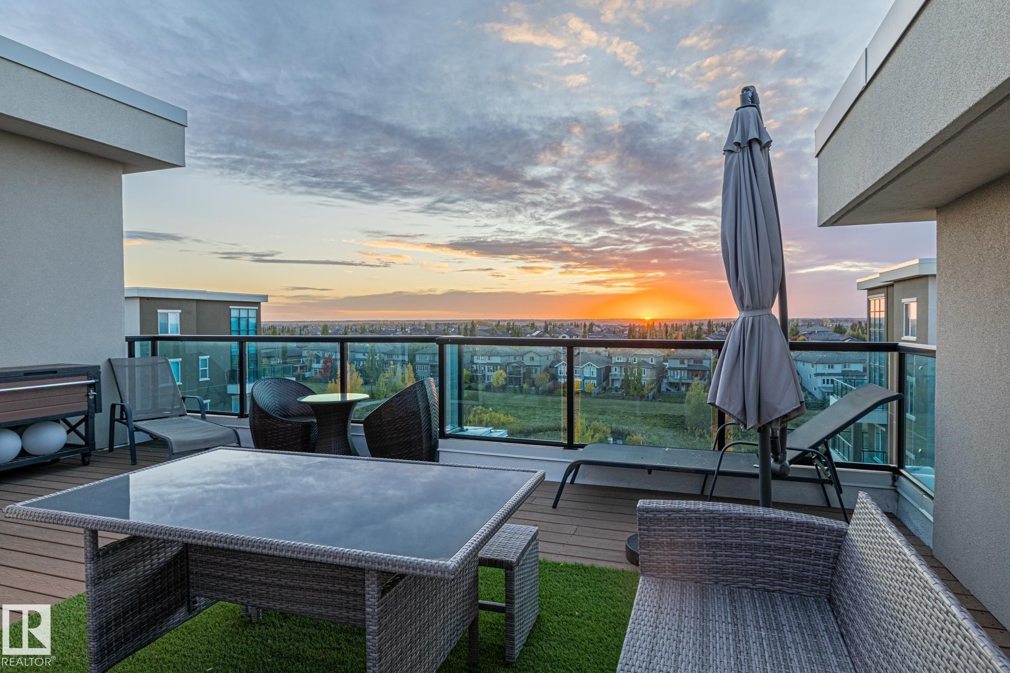 Contemporary multi-story facade featuring expansive balconies with glass railings - 513 1230 Windermere Way, Edmonton, AB