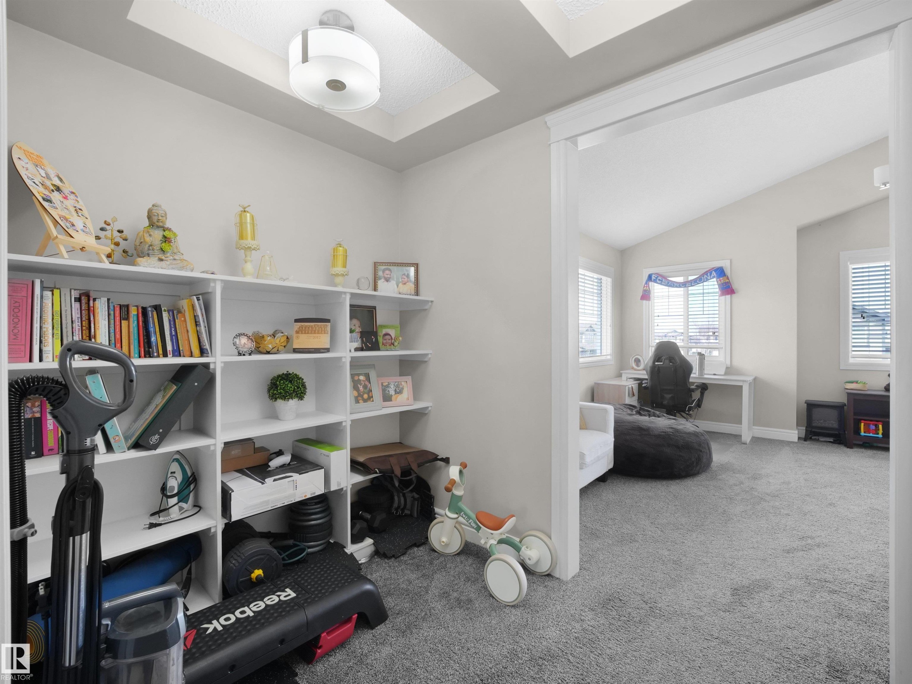 Built-in white shelving featuring a tray ceiling with recessed lighting - 3247 15 Avenue Nw, Edmonton, AB