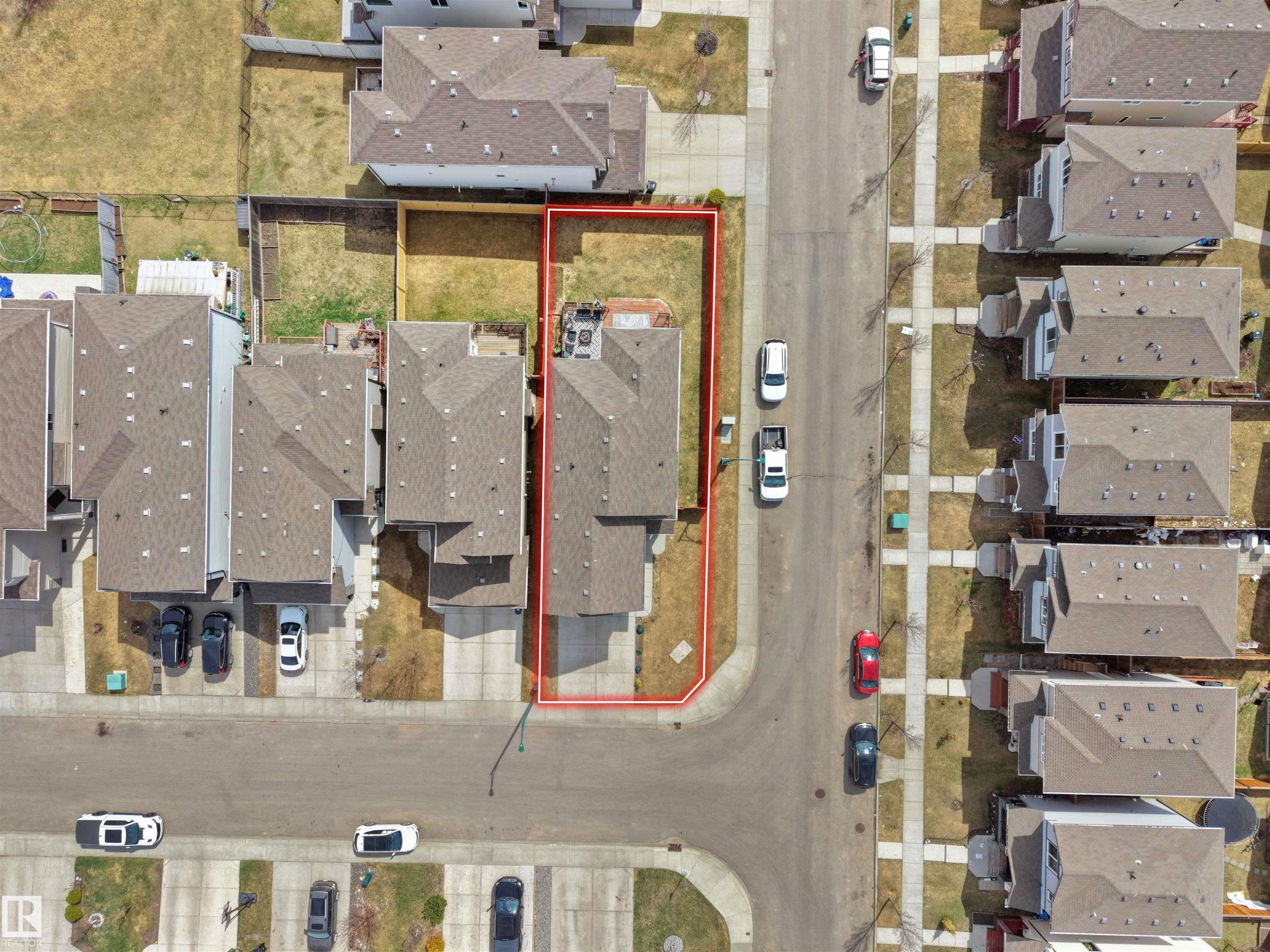 Aerial perspective showcasing a residential property with a fenced backyard and paved driveway - 3247 15 Avenue Nw, Edmonton, AB