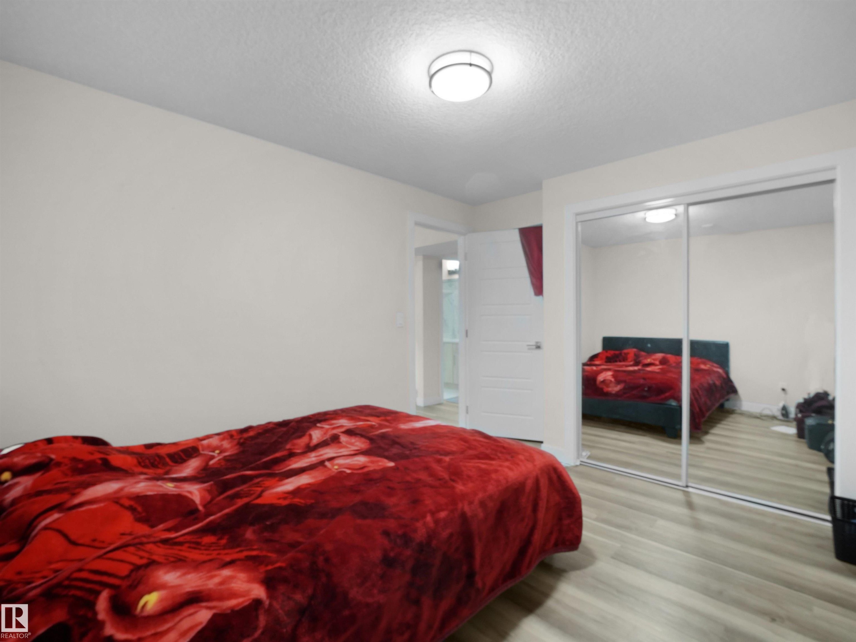 Light-toned wood-finish flooring provides a neutral palette for this room - 3247 15 Avenue Nw, Edmonton, AB